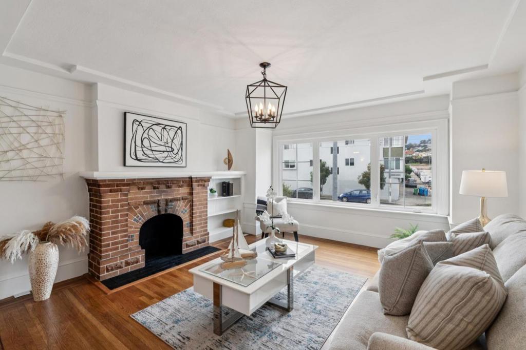 Timeless San Francisco architecture meets modern comfort at 1849 San Jose Avenue. This beautifully maintained home sits on an oversized lot with convenient access from the rear alley, offering exceptional versatility and expansion potential. Inside, classic period details shine through with elegant crown molding, tall baseboards, a brick wood-burning fireplace with an oversized mantel, and rich trim work. Natural light fills each room through large windows, enhancing the warmth of the gleaming floors and cozy fireplace. The dining room showcases charming built-ins and sconce lighting, while the kitchen blends original character with modern updates and a kitchen nook overlooking the yard. High ceilings, thoughtful craftsmanship, and a seamless flow create an inviting sense of space throughout. Perfectly positioned near the Glen Park and Mission corridors, this home offers easy access to BART, local cafes, and neighborhood conveniences. The oversized yard, spacious laundry area, and deep garage provide ample room for storage, easy expansion, and future ADU potential.