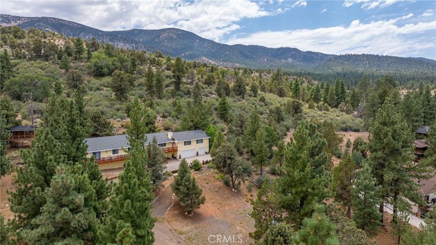 What's not to love? A huge, spacious and open floorplan with 2 of the greatest of the great rooms. Follow the meandering driveway up the gentle, slightly sloped lot to this just under,this 1.37-acre parcel backing to the National Forest. 4 bedrooms, 2.5 baths, an enormous game room, two fireplaces, formal dining, and a pantry. Tankless water heater. massive storage, cathedral ceilings. Plenty of room for your horses and all of your animals. Room for a Barn and corrals. National Forest Riding and hiking trails. Possible snowshoeing and cross-country skiing after a good snowfall. Beautiful vistas from the front deck towards Gold Mountain. Furnishings are negotiable. Custom blinds, plumbed for soft water system. Sewer, water, gas, and electricity are all connected. Be sure to note the custom firepit. Another outdoor surprise is the tree house or play house, which will also serve as a "she shack" or "man cave". Outdoor video and ring Doorbell.