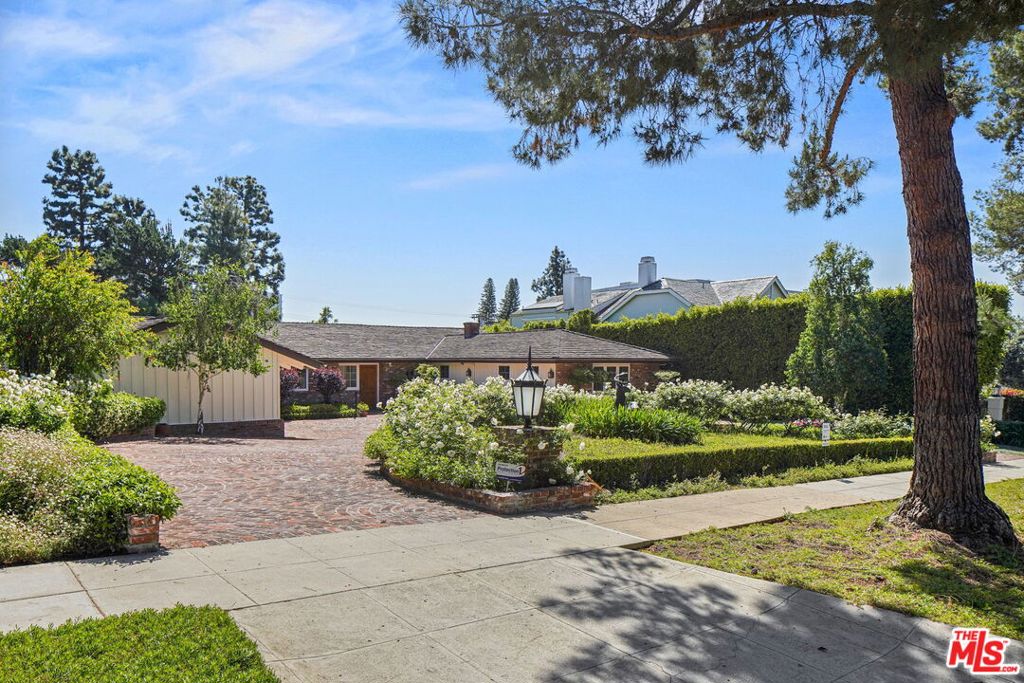 First time on the market in over 50 years! Incredible opportunity to build a new spectacular residential estate or renovate the present one-story home on a prime, fully usable almost 1/2 acre lot. This charming ranch style home in the Beverly Hills Flats features exposed wood beams, custom built-ins and hardwood flooring. Large sliding glass doors create a seamless indoor/outdoor feel, while showcasing the beautiful, sprawling manicured grounds. Each of the generously sized bedrooms are en-suite, while the grand primary suite opens to the amazing grounds. Backyard features extraordinary mature trees circling the yard for great privacy as well as resort style pool & spa complete with waterfall. Large circular motor court with attached two car garage. This one-of-a-kind opportunity is minutes away from the Beverly Hills Hotel, Rodeo Drive, and all that Beverly Hills has to offer. Possibilities are endless.... vacant and easy to show!