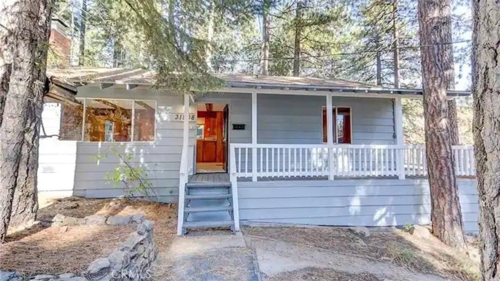 2 Units for the price of 1!........
Indulge in the serene charm of this beautifully maintained 2-bedroom mountain retreat, complete with a fully equipped bonus studio. Perfect for families, professionals, or those seeking a peaceful escape, this property offers the ideal blend of comfort, privacy, and versatility........
The private-access studio features its own kitchen, full bathroom, AC/heating split system, and dedicated laundry room with washer and dryer—making it ideal for guests, extended family, or even rental income potential.......
Enter from the street level to discover ample flat parking for 6 cars, and a thoughtfully designed single-level layout with both bedrooms on the same floor for added ease and convenience. Inside, the cozy living area boasts mountain-inspired wood accents and a charming wood-burning/gas fireplace flanked by a plush couch—perfect for relaxing evenings in.....
Step out onto your private deck to soak in the peaceful beauty of surrounding pines and a clear, starry sky. Enjoy the modern convenience of a brand-new tankless water heater (installed just last month) and a fully stocked kitchen that blends seamlessly with the home’s rustic character.....
Outside, the expansive deck is perfect for sipping morning coffee or enjoying an al fresco meal with breathtaking mountain views. Additional amenities include a flat-screen TV and four to five flat on-site parking spaces......
Adventure awaits just minutes away with opportunities for hiking, biking, and skiing. When you're ready for shopping, dining, or seasonal festivities, nearby Running Springs offers local charm and community events. And within a quick 20-minute drive, Lake Arrowhead Village welcomes you with lakeside restaurants, live entertainment, and year-round activities......
Escape the ordinary and embrace the tranquil beauty of life on Luring Pines. Surrounded by majestic trees and serene mountain views, this home is your perfect hideaway in nature.