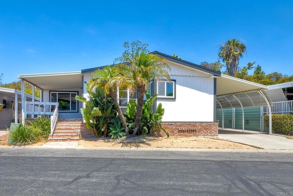 Welcome to your own slice of paradise in your Golden Years! Nestled within the highly sought-after Rancho Carlsbad Estates 55+ community, this beautifully remodeled 3-bedroom, 2-bath home is ready for you to move right in and start living your best life. Step inside and be greeted by inviting luxury vinyl plank flooring that flows seamlessly throughout the open-concept living spaces. The brand-new kitchen is a chef’s dream, boasting stylish quartz countertops, crisp white shaker cabinets, stainless steel appliances, and an elegant Italian tile backsplash. Soaring vaulted ceilings in the living room and kitchen, paired with expansive new windows, bathe the home in an abundance of natural light. Every detail has been thoughtfully considered, from the modern lighting fixtures throughout to ceiling fans in every bedroom for year-round comfort. The primary bathroom is a true retreat, featuring a spacious walk-in shower with a custom frameless glass door, new vanities, designer lighting, and chic mirrors that create a spa-like atmosphere. Step outside to your private backyard oasis, complete with a covered patio and turf area—perfect for relaxing or entertaining under the SoCal sun. Mature orange trees and tropical landscaping frame a picturesque seasonal creek, offering both beauty and privacy in one of the community’s most desirable locations. Brand new roof is an added bonus! Enjoy an array of resort-style amenities, including a year-round heated pool, spa, fitness center, tennis and pickleball courts, and more. The vibrant clubhouse features a ballroom, table tennis, billiards, card room, arts and crafts studios, and a two-story library. Host gatherings on the outdoor patio with a built-in gas BBQ, or tee off at the on-site public golf course—there’s truly something for everyone! All of this, just minutes from Carlsbad’s stunning beaches, shopping, and dining. Embrace the lifestyle you deserve—welcome home to the Golden Years at Rancho Carlsbad Estates!