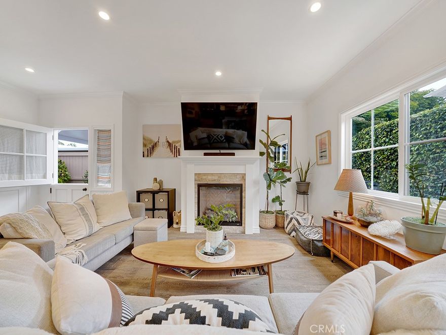 Nestled in the heart of San Clemente's illustrious Spanish Village by the Sea, this light-infused townhome serves as the quintessential beach retreat. Relish in breathtaking panoramic ocean vistas from the picturesque rooftop terrace, as the sun dips beneath the horizon, casting a serene ambiance over this three- bedroom, and three-and-one-half bathrooms. Boasting an array of upgrades, interiors of approximately 1,745 square feet are characterized by numerous upgrades such as crown molding, wide plank ceramic flooring, and a sophisticated designer kitchen complete with top-tier stainless steel appliances, farmhouse sink, and bar seating. Step from the cozy living/dining area, warmed by the fireplace and featuring glass sliding doors, onto the outdoor patio, a perfect setting for either entertaining, barbecuing, or relaxing in the soothing ocean breeze. Rounding out the main level, guests enjoy a light- filled bedroom with an ensuite bath, garage access, and half bath. The second level is dedicated to a spacious family room and 2 additional bedrooms including the primary suite showcasing marble countertops, soaking tub, and dual vanity sinks. Enjoy the convenience of a premier location, mere minutes from world-class beaches, San Clemente Pier, Linda Lane park, fine dining, and upscale shopping along the renowned Del Mar Street. Embrace the essence of coastal living at this charming home, where every day feels like a vacation.