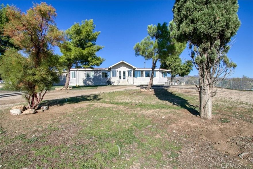 Welcome to your serene Anza dream home, only 0.8 miles off the paved road.  With a view overlooking the nearby valley, you'll love the enclosed Arizona style sun room porch.  Open the windows to feel the cross breeze, or keep them closed and enjoy the natural light and the view.  Nestled on 2.75 acres, this horse property is ready for all your critters, your family members and all your entertainment needs. The possibilities are endless.  Add an ADU, run a business, or just spend all day working the land with your four-legged friends.  



This manufactured home is on a permanent foundation with a 433a certificate, making it eligible for most financing. It is even inside the eligible area for the 0% down USDA loan.



This home offers 3 bedrooms and 3 bathrooms, designed with versatility in mind. The spacious primary suite has a roomy, gorgeous bathroom with quartz countertops, a walk-in shower and ample storage.  The primary suite even has its own retreat. The retreat provides flexible space that can serve as a nursery, home office, or even a dream walk-in closet. Inside the main living area, you’ll also find a Jack-and-Jill style guest bathroom that links the laundry room and the second bedroom. The third bedroom is an expansive 10' x 34' with a walk-in closet and private entrance, ideal for multi-generational living, guest quarters, or rental potential. 



The heart of the home shines in the recently remodeled kitchen, featuring crisp white cabinetry, sleek quartz countertops, and stylish open shelving. A walk-in pantry keeps everything organized, while the included stove, refrigerator, and dishwasher make it truly move-in ready. It’s a perfect space for both everyday living and gathering with family and friends.  



Step outside and discover endless possibilities. The Rural Residential zoning allows for horses, goats, chickens, and more.  With a cross-fenced dog yard, you are ready to keep your four-legged friends safe when guests come to visit. A spacious workshop with a full bathroom adds convenience and flexibility, while the property’s private well and owned propane tank provide self-sufficiency. Out back, a charming gable-roof pergola creates the perfect setting for outdoor entertaining or can even double as covered RV parking. With plenty of space and the option to build an additional dwelling, this property offers both comfort and opportunity.



Set your GPS to the corner of El Campo/Coyote Canyon Rd, then to house, you'll minimize dirt roads