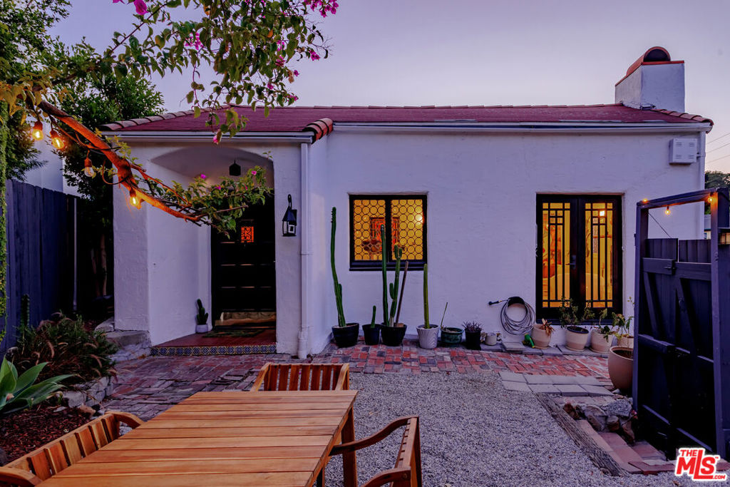 Welcome to "Casa Casablanca", a 1920s Spanish cottage that transcends time high above the boulevard in Whitley Heights, steps from the Hollywood Bowl. This masterpiece was meticulously designed by Oscar-winning art director Carl Jules Weyl, famed for bringing cinematic masterpieces like "Robin Hood" and "Casablanca" to life. This 2-bedroom, 2-bathroom treasure offers a blend of historical elegance and modern convenience. As you step in through a gated courtyard patio, inviting manicured grounds welcome you to this stunning Spanish cottage. Inside, vaulted beamed ceilings soar above intimate spaces, casting light through whimsical bottle glass stained windows, skylights, and archways. The 1,133-square-foot interior features exquisite details, including built ins, moldings, and a sunken bathtub that invites relaxation. Open the balcony doors to enjoy a breath of tranquility overlooking the lush lower yard, your personal retreat amidst the vibrant city life. This home offers essential modern amenities like air conditioning, washer/dryer, Bosch refrigerator & dishwasher, Viking stove, and two remodeled bathrooms. The residence's multiple private outdoor spaces offers the perfect canvas for your personal touch with views of the hills. Located in the heart of Hollywood in Whitley Heights, you are walking distance to the iconic Hollywood Bowl and a stroll up to the Hollywood Reservoir. Bordering Hollywood Dell, this location is accessible to the best Hollywood has to offer with convenient freeway access. Peekaboo views of the Hollywood Sign are visible from the front door. This property offers plenty of permitted street parking in front of the property.