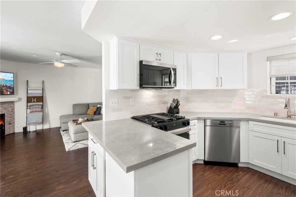 Situated within the private community of Back Bay Village in East Costa Mesa, this updated Cape Cod inspired residence offers both comfort and style. With 3 bedrooms, 2.5 bathrooms, and 1,372 sq. ft., the home blends open living spaces with thoughtful upgrades. The remodeled kitchen features sleek quartz countertops, shaker style cabinetry, and stainless steel appliances, while the living room centers around a tile trimmed gas fireplace. A sliding glass door opens to a patio retreat, perfect for outdoor dining and entertaining. Upstairs, the primary suite boasts high ceilings, a remodeled bath with dual sinks, and generous closet space. All appliances are included, even the washer and dryer, along with all patio furniture, fire pit, outdoor heaters, and barbecue. Additional highlights include recessed lighting, custom window coverings, a direct access two car garage, and modern finishes throughout. Residents enjoy community amenities including a pool and spa, with easy access to scenic trails, local parks, and the Back Bay Nature Preserve. Conveniently located near shopping, dining, and the beaches of Newport, this home balances everyday ease with coastal charm.