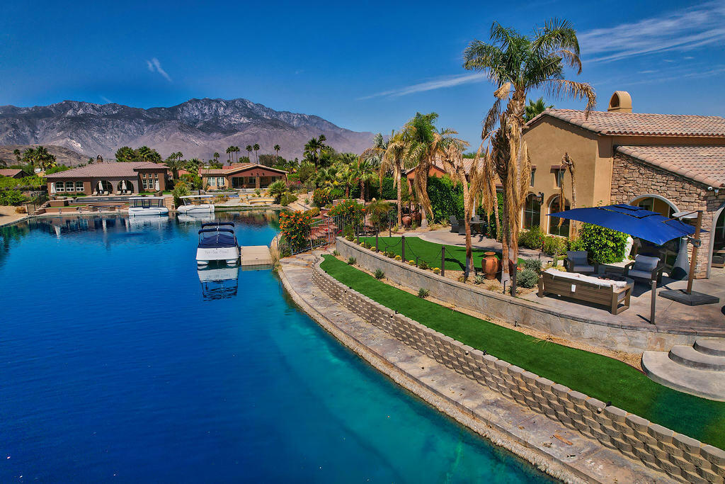 ( *Summer rate through end of October $7500mo* ) (*Booked JAN FEB MARCH 2026* ) Furnished annual lease. This home has an exceptional waterfront view on the lake in the highly desirable gated community of Santo Tomas community in Rancho Mirage California. 4 bedrooms and 4 bathrooms. Attached casita. Infiniti pool with grotto, waterfall & spa. BBQ. Fire pit. Owners include social membership to Mission Hills Country Club which allows access to world-class fitness, tennis and social activities. HOA fees, landscape maintenance, pool & spa maintenance + trash service are included. Tesla charging station in 2 car garage. This home is on the largest lot in the community and is located on a cul de sac. Owners include HOA fees, pool & landscape maintenance. $9000mo annual tenants pay utilities and screening fee. $15,000mo Seasonal Vacation bookings include utilities up to $300mo and wireless Internet. 1 closet in primary bedroom suite will be locked off for owners closet with seasonal rental bookings. Contact agent for more information.