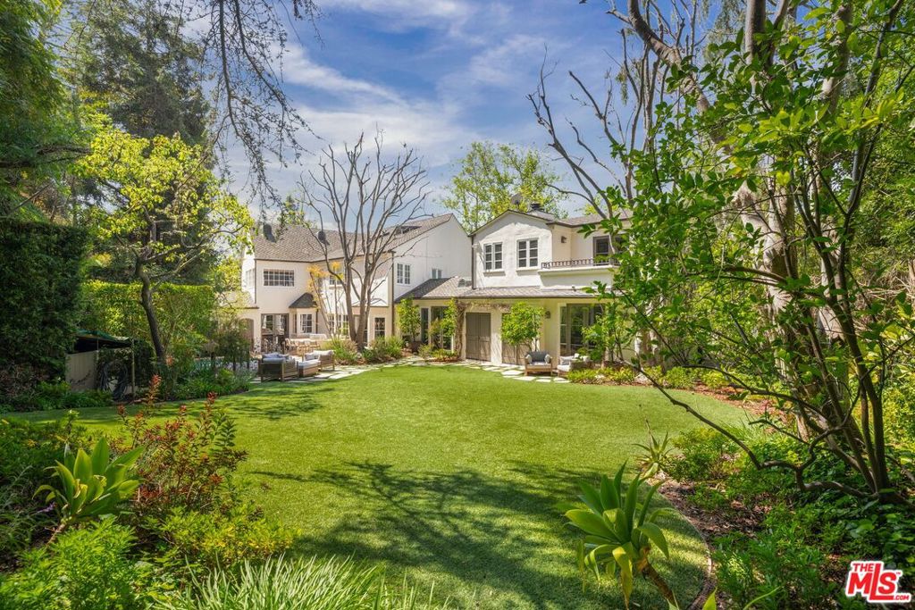 Sited discreetly beyond a gated entry, this 6-bed, 6-bath stately traditional home situated on a 40,888 sqft flat parcel exudes warmth, charm, and sophistication. The main level consists of a formal living room with vaulted ceilings and wooden beams. Across the hall, you are led directly into an impressive dining room accompanied by a wooden wet bar along with an elegant fireplace showcasing a detailed custom mantel. An elegant hall leads you directly into an impressive sun-soaked warm and cozy family room with green-painted walls. Enter the gourmet kitchen with a center island highlighted by professional-grade appliances and a breakfast nook with French doors that open to the outdoor oasis featuring, landscaped gardens, a pool/spa, a basketball court, and a studio. Ascend to the upper level to an impressive primary suite boasting a walk-in closet, and a spa-like bathroom including a steam shower with double vanities and a grand tub. There are four additional bedrooms, a gym, and a beautiful study room. Conveniently close to top-rated schools, world-class dining, and entertainment. This is the perfect home for the California lifestyle.