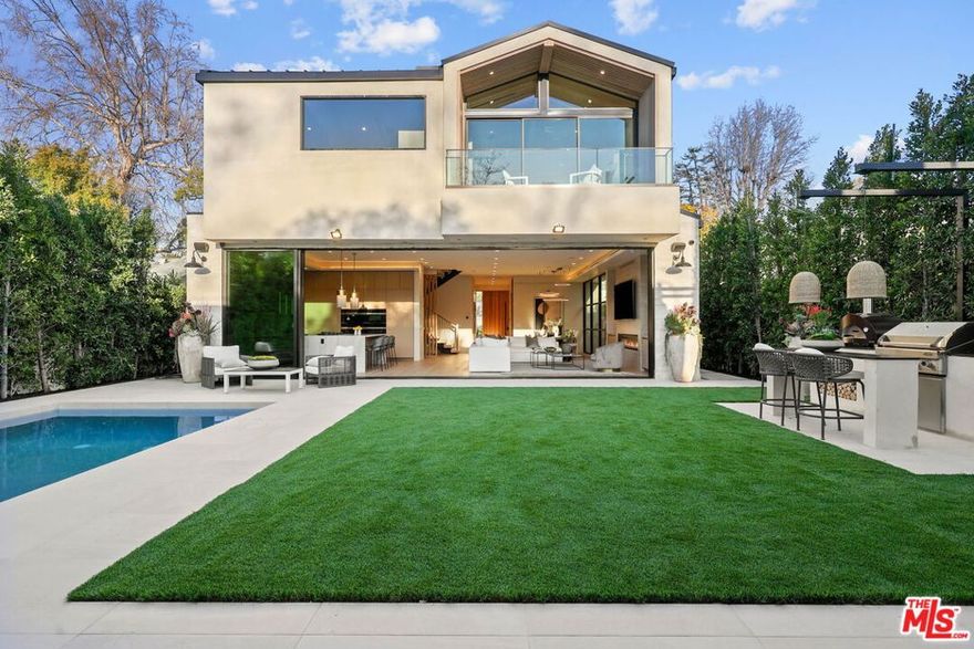 REDUCED $100K...SELLERS ARE RELOCATING                                                                                                                  In the heart of Studio City,  this newly built modern farmhouse offers the perfect blend of contemporary sophistication and timeless warmth. The main house features 4 spacious en-suite bedrooms and 5 bathrooms, with soaring ceilings, wide-plank oak floors, cove lighting, and floor-to-ceiling glass sliders that create seamless indoor-outdoor flow. The entertainer's backyard includes a pool, spa, built-in outdoor kitchen, and private grassy lawn bordered by mature hedging. The chef's kitchen is a true showpiece, boasting custom oak cabinetry, LED-lit smoked glass shelving, and top-of-the-line built-in Miele appliances including a 6-burner stove, hidden hood, double ovens, oversized fridge/freezer, and built-in coffee system. The vaulted primary suite features wood-paneled ceilings, a fireplace, private terrace, spa-like bath, and custom walk-in closet. A lower-level en-suite bedroom offers flexibility for guests, office, or gym. The detached 1 bed / 1 bath ADU with full kitchen and pitched ceilings that opens up the feel of the yard with the back wall having a large glass window is ideal as a guest house, studio, or income opportunity. Located near the Shops at Sportsmen's Lodge, with easy access to the 101 and Westside through Beverly Glen, Coldwater, or Laurel Canyon. Zoned in sought after Dixie Canyon Community Charter and close to several private schools in the area. Seller's motivated!