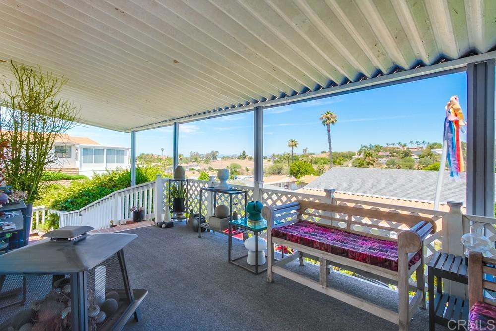 Enjoy cool ocean breezes and wonderful views of the surrounding hills from this home in highly desired Palomar Estates West. The open floor plan and 1,770 square feet of living space make this home very spacious. A three bedroom and two bath house is a unique find in this community. The updated kitchen has beautiful cabinets and solid surface counter tops, stainless steel appliances, and a skylight to provide wonderful natural light. The primary suite has a retreat area, large walk-in closet, and on-suite bathroom with dual vanities, a tub, and a stunning tiled shower. The property and outdoor areas feature lots of privacy yet is only located five homes away from the clubhouse facilities. The home has a large shed to store your extra items. The home had a new roof installed in April 2025. Palomar Estates West is a 5 star 55+/35+ senior rent controlled park with many activities and amenities including a beautiful clubhouse, pool, spa, gym, putting green, pickleball courts, and tennis courts. This home is located minutes to Lake San Marcos dining and golf as well as local Carlsbad beaches, shopping, and restaurants.
