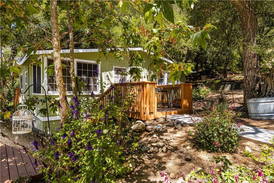 Tucked away in the peaceful hills of Modjeska Canyon, this enchanting 1-bedroom, 2-bathroom retreat offers the rare opportunity to live in a piece of history. Set on over 2 acres, this home is surrounded by towering trees, vibrant wildlife, and miles of nearby hiking trails. Step outside and instantly feel a world away with nature as your neighbor and just 20 minutes between East Orange and Foothill Ranch. Inside, the home maintains its vintage charm while offering the essentials for cozy living and a restful escape. Large windows invite in natural light and tranquil views, creating a peaceful, storybook atmosphere throughout. Outdoors, the nearby creek offers a daily peaceful serenade. Whether you’re seeking solitude, inspiration or a simpler way of life, this property delivers! Ideal for artists, adventurers or anyone craving space and serenity. This is more than a home - it’s a rare sanctuary in one of Orange County’s most hidden gems.