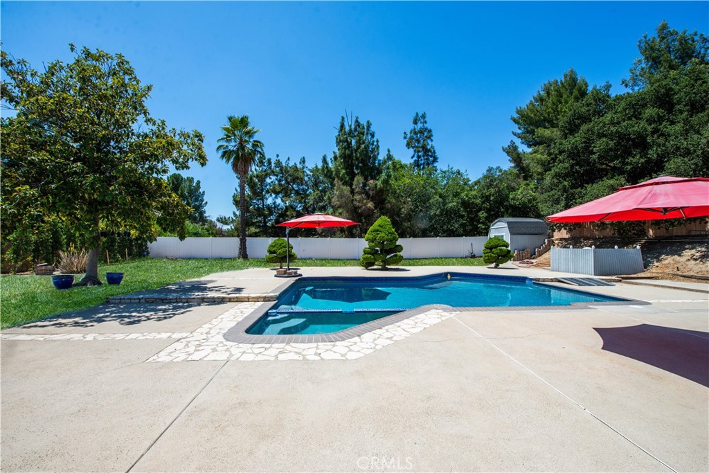 Experience the perfect blend of luxury and comfort in this expansive single-story estate, offering 4 bedrooms, 3 baths and 3,021 sq ft of living space in the highly sought-after Knollwood Country Club Estates area. Step inside to find two impressive living and family rooms, each with its own fireplace, vaulted ceilings, and oversized glass sliders that frame serene views of the entertainer’s backyard—creating a seamless indoor-outdoor flow. The elegant dining room opens to a private front gated courtyard, providing an inviting additional space to relax or host. The remodeled chef’s kitchen is a dream, featuring coffered ceiling, stainless steel appliances, three ovens, stone countertops, and custom cabinetry with abundant storage. The spacious primary suite is a true retreat, complete with double sliders to the backyard, a walk-in closet plus two additional closets, and an oversized spa-inspired bath with dual sinks, soaking tub, and separate shower. Three additional generously sized bedrooms each enjoy access to their own baths. Set on a private, flat 17,286 sq ft lot backing to the 11th hole of Knollwood Golf Course, this property is an entertainer’s paradise with a sparkling pool, spa, expansive patio, and plenty of room to add your dream amenities. The rare three-car garage offers potential for additional living space, a 5th bedroom, or even a junior ADU. This well maintained home has been thoughtfully updated with newer flooring, newer HVAC, updated roof, dual-pane windows and sliders, crown molding, and mirrored closet doors. Ideally located near shopping, dining, and easy freeway access, this home offers the best of Southern California living.