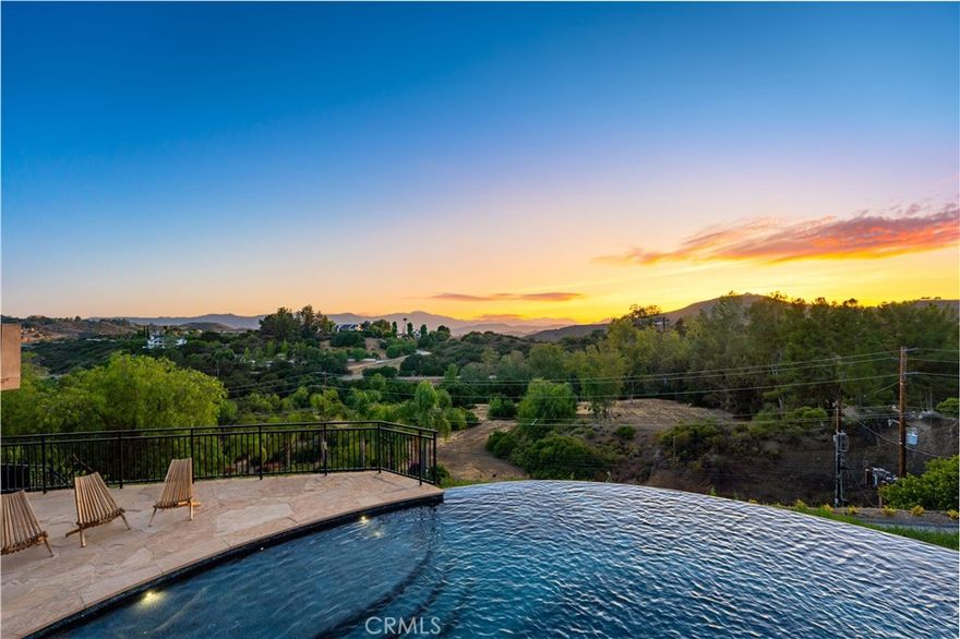 Gated Estate | Fully Landscaped | Unforgettable Views
Tucked into the tranquil beauty of the Santa Monica Mountains, this estate is a rare find—blending architectural elegance with nature’s finest views. Perched just off the iconic Mulholland Highway and resting on nearly an acre of fully landscaped land, this 4,579 sq. ft. residence offers an unmatched lifestyle.Enjoy some of the most breathtaking views in the entire Santa Monica Mountain range, with sunsets off the patio that will truly take your breath away.Originally built in 2008, the home features a brand new negative-edge pool and spa oasis, complete with cascading waterfalls for a true resort-style experience. The outdoor space is an entertainer’s dream, boasting a fully equipped kitchen with a built-in pizza oven, high-end grill, and prep area—all set against a stunning mountain backdrop.
Inside, the chef’s kitchen is outfitted with a Viking 8-burner stainless steel range and an oversized center island, perfect for hosting and everyday living. Throughout the home, you’ll find beautiful hardwood flooring, along with rich alder wood finishes including custom casement windows, French doors, interior doors, and baseboards.The main level offers light-filled living areas with a southwest-facing orientation, while four spacious bedrooms are located on the lower level. There is also ample room to further customize the home to your vision.
Located just seconds from Viewpoint School and within the award-winning Las Virgenes Unified School District, this gated estate is ideally positioned just minutes from Malibu’s beaches and the Calabasas Commons—offering the perfect blend of natural serenity and everyday convenience.