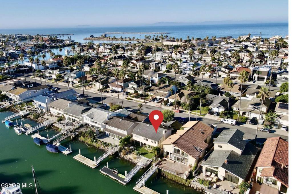 Rent paradise in Ventura Keys!Located on the highly sought-after Island in Ventura Keys, this stunning waterfront home offers luxury living with a 35-foot dock and elegant upgrades throughout.This beautifully designed home features an open-concept layout that seamlessly blends indoor and outdoor living. The first floor includes a bedroom, a chef's kitchen with stainless steel appliances, and an adjacent breakfast nook with French doors leading to a private courtyard with a hot tub. The dining area and dry bar flow effortlessly into the spacious living room, where a fireplace and multiple glass sliders provide direct access to the back deck and dock. A generously sized guest bathroom with a shower completes the first floor.Upstairs, three bedrooms offer incredible water views, including the primary suite with an en-suite bathroom. Each bedroom is equipped with remote-operated window shades for added convenience. An additional hall bathroom serves the second floor.The outdoor space is designed for both relaxation and entertainment, featuring artificial grass and a fire pit on the back deck overlooking the water. Laundry is conveniently located in the garage.Call for short-term pricing!