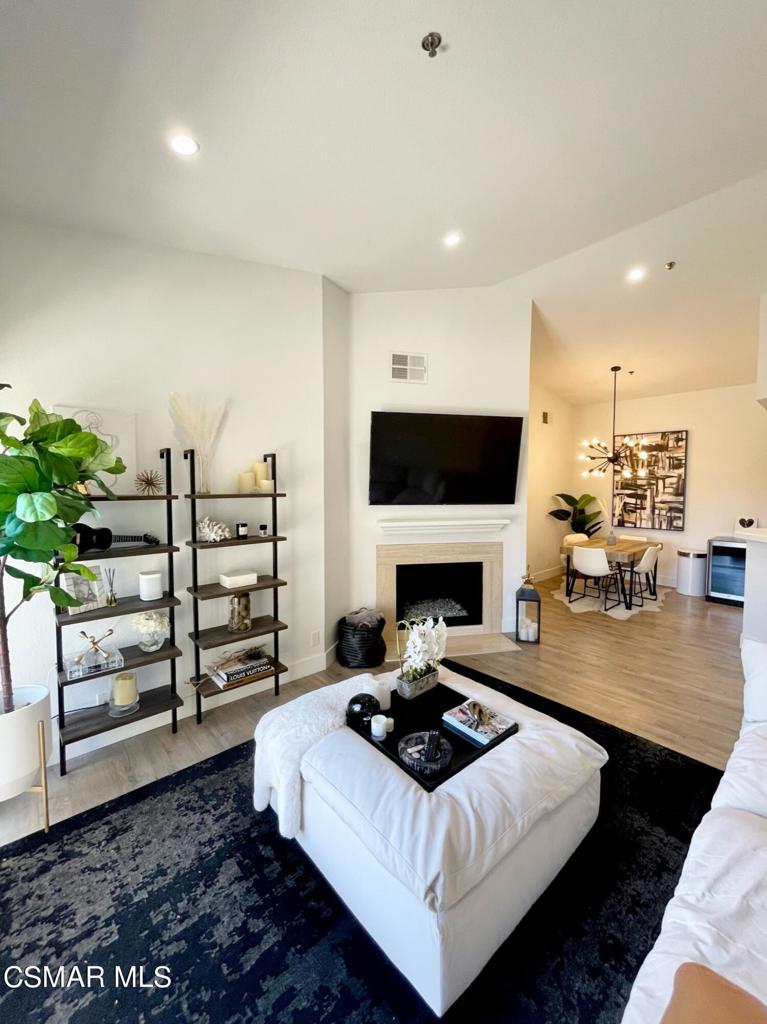 Welcome to this beautifully remodeled (just in 2019) open floor plan condo, located on the top floor offering an abundance of great natural lighting as well as the gorgeous mountainside view. Upon entry you are greeted with neutral, plank flooring, recessed lighting, high 20ft+ ceilings and smooth ceilings create a nice sense of space. The one bedroom suite features a large walk-in closet with organizers and slider access to the patio where you can unwind and take in the lush green scenery. The bathroom has been completely gutted and remodeled and features a large stall shower, marble stone topped vanity, an LED backlit vanity mirror and a chic barn door closure. The fireplace also has been updated for a fresh, modern look. You'll be hard pressed to find a better location than this. The balcony floor and railing were redone by the HOA in 2021. The spacious balcony also features a storage closet with washer and dryer. Internet and cable are included along with a Nest smart thermostat and Nest camera doorbell that can be controlled with the Nest app. Shadow Ridge is located close to Oak Park schools, hiking trails and a dog park. Take advantage of the incredible resort-like amenities included with this stunning community. Enjoy the private lush walkways, or a game of volleyball, tennis or basketball on the sport courts. Gym amenities also included. Bask in that So Cal sunshine too at either of the 2 community pools and spas. Includes one deeded covered parking spot plus additional guest parking.