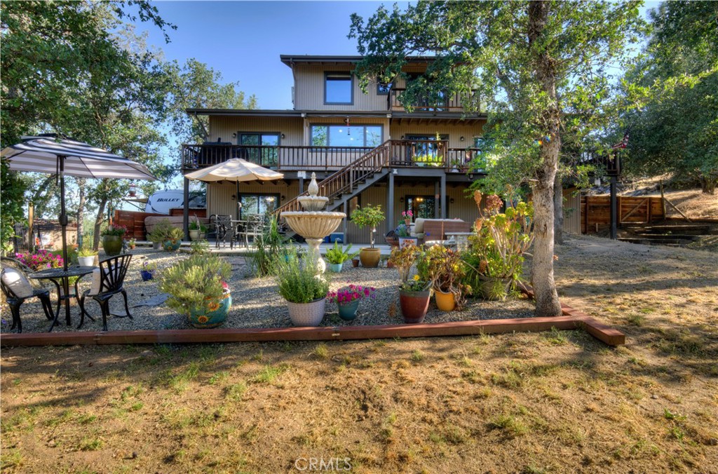 Discover one of the most unique and beautiful homes in Yosemite Lakes Park. This updated 4-bedroom, 3-bath custom home is full of charm and thoughtful upgrades. Enter through a custom glass door to a warm, rustic interior featuring a weathered wood accent wall and vaulted ceilings. The living room centers around a freestanding wood stove with a rock wall backdrop, while the dining area includes a wet bar with a copper sink. The kitchen features newer granite countertops and custom cabinetry.
The main level has two bedrooms, including one with deck access. Upstairs, the primary suite offers a jetted tub and a stone-and-tile shower. Downstairs, a bonus space/in-law setup includes its own kitchen, living area, bedroom, and bathplus a fully furnished saloon room perfect for entertaining.
Situated at the end of a quiet cul-de-sac, this 2+ acre property offers privacy, natural beauty, and usable land with pines, oaks, granite outcroppings, a seasonal creek, and small pond. Horse amenities include a tack room and round pen area. Enjoy peaceful mornings on the spacious front patio.
A brand-new, fully furnished log cabin tiny home - valued at $65,000 - offers the perfect guest space or Airbnb opportunity, tucked away in its own private setting. All within a community featuring a golf course, pool, tennis courts, clubhouse, and walking trails.