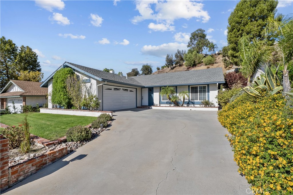 Move right in to this lovingly maintained, move-in ready 3-bed, 2-bath home that radiates pride of ownership. The moment you arrive you’ll appreciate the great curb appeal with updated roof, windows, doors, fresh exterior paint, and immaculate landscaping. Inside, high ceilings and abundant natural light accentuate the wood floors throughout. The floor plan feels open yet defined, with a living room up front and a spacious family room for entertaining. The kitchen features granite countertops, a breakfast nook, and a bar that opens to the family room, along with stainless steel appliances. The primary suite includes its own private bath and walk-in closet. Outdoors, the backyard is charming and private with a covered patio and a comfortable sitting area perfect for relaxing or entertaining. The large 10,000+ sq ft lot offers plenty of outdoor space and beautiful curb appeal. With no HOA, no Mello-Roos, and close proximity to Canyon Country Park and Sierra Hills Community Center with optional amenities, this home truly shows beautifully and is ready for its next owner.