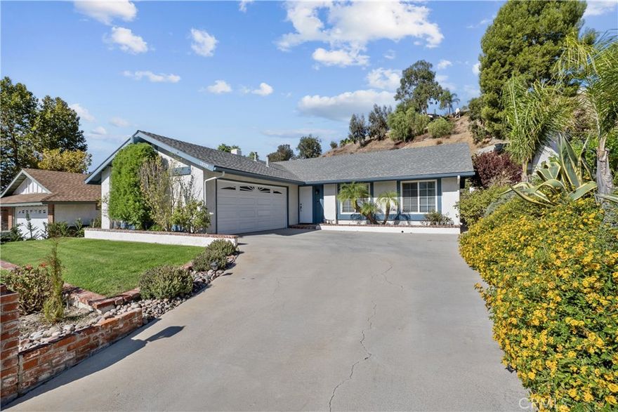 Move right in to this lovingly maintained, move-in ready 3-bed, 2-bath home that radiates pride of ownership. The moment you arrive you’ll appreciate the great curb appeal with updated roof, windows, doors, fresh exterior paint, and immaculate landscaping. Inside, high ceilings and abundant natural light accentuate the wood floors throughout. The floor plan feels open yet defined, with a living room up front and a spacious family room for entertaining. The kitchen features granite countertops, a breakfast nook, and a bar that opens to the family room, along with stainless steel appliances. The primary suite includes its own private bath and walk-in closet. Outdoors, the backyard is charming and private with a covered patio and a comfortable sitting area perfect for relaxing or entertaining. The large 10,000+ sq ft lot offers plenty of outdoor space and beautiful curb appeal. With no HOA, no Mello-Roos, and close proximity to Canyon Country Park and Sierra Hills Community Center with optional amenities, this home truly shows beautifully and is ready for its next owner.