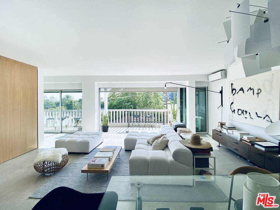 Welcome to Doheny West, newly renovated, full service and luxuriously appointed throughout. With a prime location at the intersection Doheny and Sunset in West Hollywood, this designer renovated space offers the ultimate in city living. Step inside to an open and airy minimalist loft-like layout, complete with one bedroom, one bathroom, and a 35 foot covered patio that seamlessly blends indoor and outdoor living. The spacious living area features Fleetwood multi-slide stackable glass doors flooding the space with natural light and breathtaking views of Century City and even the ocean on a clear day. The kitchen is a chef's dream, with sleek Ernesto Meda cabinets, Carrara marble countertops, Epoxy dexotex floors and top-of-the-line Miele and Wolf appliances. The bathroom is equally luxurious, with Carrara marble mosaic tiles, a Toto toilet, and a Duravit sink. Throughout the apartment, you will find custom-made storage: matte white oak closets in the entry and bedroom, matte white oak hideaway bookshelf, electric blinds and Lutron lights. Designer furniture includes a Le Corbusier Cassina glass table, Aero Saarinen velvet armchairs, B&B Italia Tufty Time sofa by Patricia Urquiol, and a Ligne Roset coffee table. There is a 70-inch flat-screen TV on a retractable arm. The space is also filled with beautiful artwork by Chris Newman and Franco Marletta. Amenities included in the rent are cable, internet, water, and trash. There is a mini-split HVAC system, 1 car parking space, and valet guest parking. The full service building has a 24 hour concierge/doorman, security, valet for guests, pool, gym and laundry facilities. Located in the trendy West Hollywood Hills area with close proximity to some of the best restaurants, shops and hotels. Mandatory renter's insurance and cleaning services available at $120/week. One year/6 month flexible lease term.