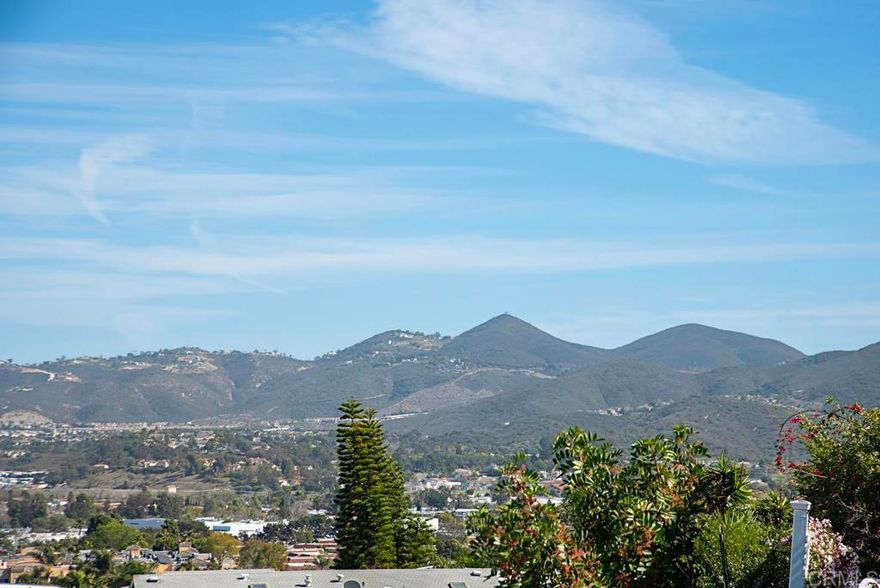 Panoramic VIEW property located on an elevated lot on a cul-de-sac within a 55+ resort style community w/ rent control.  Private wrap around deck with sweeping views to the North East.  This roomy 1840 sq. ft. home gives enough space for a formal Dining area, Family room and Living room with fireplace.  Newer HVAC, water heater, and refrigerator.  Vaulted beamed ceilings and vinyl windows enhance the richness of the color palette.  The Primary Bedroom has a large walk in closet and ensuite Bathroom with a large soaking tub and separate step in shower.  The laundry room is oversized with an extra pantry, storage cabinets and counter space.  There is also an enclosed porch that can serve as an office or hobby room.  Large Storage shed.  Rancho Vallecitos is a beautiful, 5-Star, resort style community for persons 55 years of age and over (2nd resident can be age 45+). One of the most beautiful manufactured home communities in California, Rancho Vallecitos has great views that can be enjoyed throughout the community, plus many social activities and amenities. Amenities include a clubhouse/recreation building, pool & spa, library, gym, billiards room, card tables, game and craft room, putting green, dog park, RV parking for an additional cost, and so much more!  Monthly space rent is $740 and park is under city rent control.