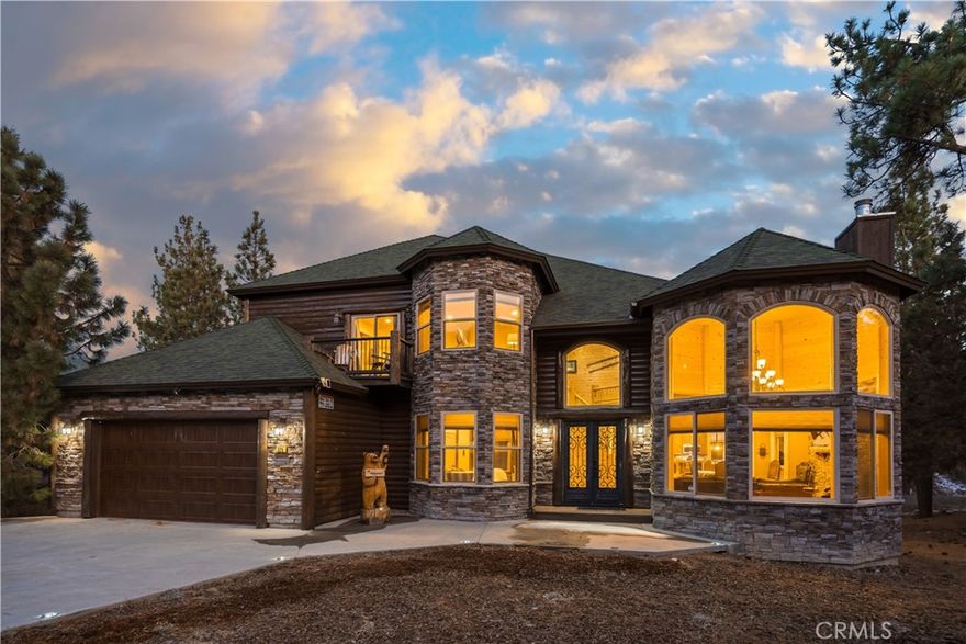 Welcome to Big Bear’s Grand Chateau, your ultimate multi-family getaway! Featuring rustic cabin accents, vaulted entry and living room ceilings, and modern home amenities, this 4,000 square foot home is sure to impress and become the foundation for creating lasting family memories. Both levels boast their own master suite, complete with jacuzzi bathtubs, and each of the other bedrooms connect directly to a bathroom, allowing for intimate privacy for each of your guests or family members. The open-layout kitchen has everything a master chef needs to cater to their party, with plenty of serving space attached to a large formal dining room, located beside the grand formal living room, complete with a stone-clad fireplace. The spacious two-car garage has been converted to a climate-controlled game room, complete with a pool table, air hockey, and even a jukebox, for hours of entertainment. The back deck off of the family room opens to beautiful alpine scenery, with overhead heaters to supplement a cup of hot cocoa on a snowy Sunday morning, and a short walk down into the yard reveals a veranda nestled into the surroundings, containing a large jacuzzi and outdoor firepit, all with their own overhead heating system for those snowy winter evenings after a day on the slopes. This beautiful escape is walking distance from Big Bear’s Oktoberfest and Snow Play, a few minutes’ drive to grocery stores, restaurants, Ski Slopes, and the lake, and 10 minutes’ drive from the Big Bear village, providing a proximity to everything this town has to offer, yet remains within it’s own enclave to remind you that you are out of the city on vacation. Already a successful vacation rental and priced to sell, this property is sure to impress and raise some eyebrows, so be sure to tour it before it’s sold to it’s next lucky owners!