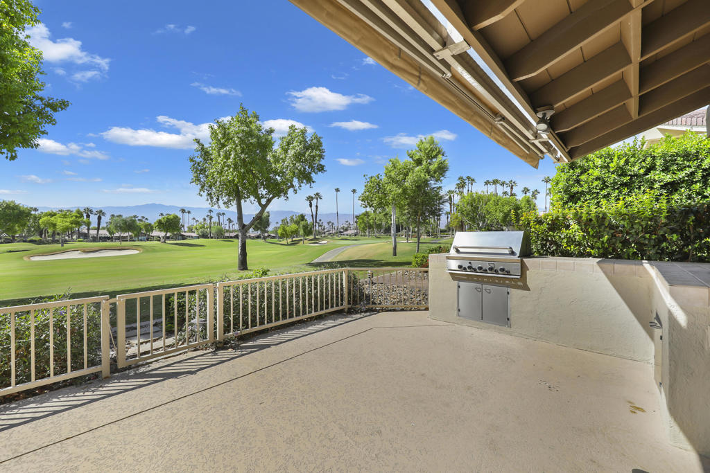 This beautifully updated 2-bedroom + den, 2-bath condo offers the perfect blend of comfort, style, and breathtaking views. The extended south-facing patio showcases expansive double fairway and mountain views, complete with a built-in BBQ, electric awning, and wrought iron viewing fence, ideal for entertaining or quiet relaxation.Inside, the remodeled kitchen has been opened to the living room, creating a bright, inclusive space featuring granite countertops and custom cabinetry. The living room boasts a cozy fireplace and sliders to the patio, while the dining area sits conveniently nearby. The converted atrium expands the den, offering a versatile bonus space.The spacious primary suite includes a generous bath, and the hallway bath features a tub/shower combo. Additional highlights include direct garage access, a 2-car attached garage, tile flooring in main living areas, and carpet in bedrooms. Offered furnished.Located in the fantastic Lakes Country Club, enjoy 27 championship golf holes, 9 pickleball courts, 4 pop tennis courts, 14 tennis courts, 4 bocce ball courts, a state-of-the-art fitness center, library, and an incredible clubhouse with restaurant and bar. It's a lifestyle