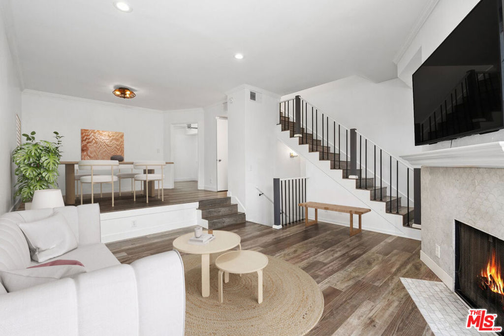 Nestled within the vibrant and artistic heart of the NoHo Arts District, this three-level townhouse is where modern elegance meets vibrant city living. Tucked away in the back of a boutique 15-unit complex this three-level townhouse is a private oasis in the heart of LA's most creative neighborhood just steps from acclaimed restaurants, boutique shops, performance theaters, and the Metro. Inside, modern elegance meets comfort with an open-concept main level featuring a large living room with a Carrera marble fireplace, newer floors with direct access to a sunny balcony overlooking the sparkling pool. A chic dining room perfect for entertaining seamlessly connects to a beautiful kitchen with stone countertops, grey subway tile backsplash, wine fridge, abundant cabinetry, and a large eat-in area, and a powder room complete the main level. Upstairs, the dazzling primary suite has soaring vaulted ceilings, a custom walk-in closet, a newly renovated spa-like bathroom (2025) with frameless shower, and a second upper-level balcony to sip coffee while soaking in the California sunshine. The second bedroom is its own retreat with an en-suite bath, and built-in closet system. A versatile bonus room on the lower level offers space for a third bedroom, home office, gym, or media room, with direct access from the private two-car garage. Meaningful additional upgrades include a brand-new HVAC system (2024) with Nest thermostat, newer flooring, freshly painted, and a 65" TV above the living room fireplace is included in sale. The community offers resort-style amenities, including a pool, spa, and BBQ area. HOA dues include earthquake insurance. This townhouse truly has it all, modern updates, an unbeatable location, and a serious wow factor. Don't miss out on this rare gem in one of LA s most happening neighborhoods! Perfectly positioned near Toluca Lake, Universal Studios, Disney Studios, Warner Bros, and more. This rare gem delivers style, convenience, and the best of LA living.