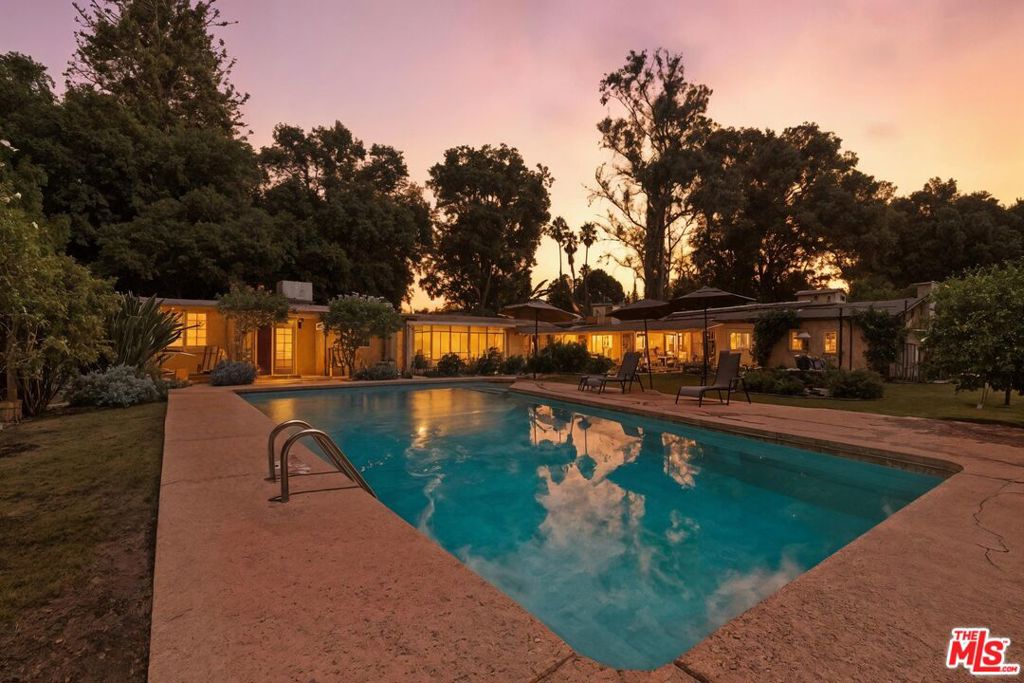 A Rare Northridge Gem on a Full Gated Acre! Welcome to 8433 Melvin Ave a truly unique opportunity to own a sprawling, gated compound in the heart of Northridge. Situated on an expansive 1-acre lot, this versatile property offers incredible potential for multi-generational living, rental income, or your own private retreat.Inside the main home, you'll find spacious living areas including a bonus room with a wet bar, a pool/exercise room, and private-access storage that can easily function as a second family room or creative studio. Step outside to discover a detached guest house with its own entrance, perfect for extended family, guests, or as a high-demand rental unit.The lush grounds are adorned with fruit trees, rose bushes, and plenty of room to garden, entertain, expand, or simply unwind in total privacy.With a little TLC, this property can become your ultimate dream compound. Whether you're seeking a creative haven, a multi-gen solution, or a place to grow the possibilities are endless.