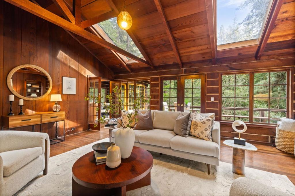 Tucked among towering redwoods, this enchanting log cabin-style home offers a serene retreat in the heart of Woodside's verdant nature. Spread across two levels, this enchanting property features three bedrooms and 3.5 baths. Skylights bathe the interior with natural light, while rich wood floors and a grand stone fireplace create a warm and inviting ambiance. Step out onto the beautiful deck with forest views, establishing a cozy and private retreat. Comprising 3 parcels (075-092-040, 075-092-050, 075-092-060), this 1+ acre property slopes gently down to a tranquil creek. The great outdoors beckons with multiple usable areas, perfect for relaxation or entertaining. And with numerous open space trailheads accessible off Skyline Boulevard, you'll have plenty of opportunities to explore natures beauty. Conveniently located near Alices Restaurant, its just a 13-minute drive to Highway 280, 20 minutes to Stanford University or the San Mateo coast. Dont forget the excellent Portola Valley Schools. Experience the allure of mountain living with the convenience of Silicon Valley and coastal access just moments away.