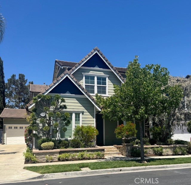 Welcome to this gorgeous home in one of the best neighborhoods in Tustin, Tustin Fields! A quiet street with pride of ownership throughout and THIS HOME IS ZONED FOR IRVINE SCHOOL DISTRICT!! The beautifully manicured and updated home features over 3100sf of family living, including a highly updated kitchen with huge center island, updated stainless appliances, quartz counters, custom fixtures, wine fridge and so much more! Huge family room off the kitchen. There is a formal dining room, spacious front room for home office or formal sitting room, downstairs 1/2 bath and large closet, large family room with built in cabinets, wood shutters, direct backyard access, built-in cabinets, "butler's" breezway with counters and storage, direct garage, side yard and back yard access, as well as a main floor bedroom with it's own 3/4 bath ensuite on the first floor. Upstairs you'll find a generous hallway with light and bright laundry room (including washer and dryer), four additional bedrooms and three more bathrooms, including a huge primary ensuite with separate vanities, separate soaking tub and large shower as well as two generous closets! Throughout the home you'll find beautiful hard surface flooring as well as cozy upgraded carpeting in select areas and on stairs, wood shutters, custom fixtures and lighting throughout! The home features a long driveway leading to the spacious 2-car garage, which includes a Tesla charger. The fabulous backyard includes a fire pit and built-in barbeque, a grassy area and patio for outside entertaining, enjoyment and relaxing! This neighborhood has it's own community park and playground as well has a large community pool! The location is walking distance to the Metrolink station - great for commuting - close to fantastic shopping (District, Spectrum, Tustin Marketplace, Fashion Island and South Coast Mall), restaurants, and entertainment. This home is a must see and you will LOVE it!