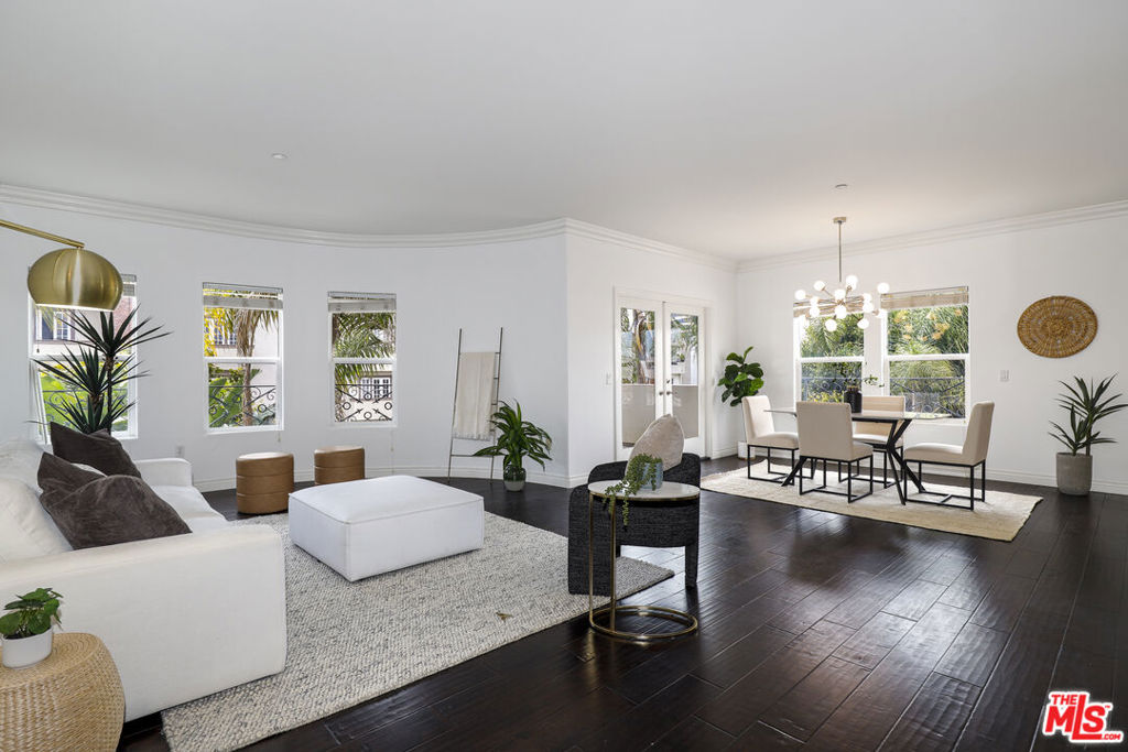 Welcome to a residence where timeless elegance meets modern luxury in the coveted Westwood Charter elementary school district! Perfectly positioned moments from UCLA, Westwood Village, Century City, and the world-renowned shops and restaurants of Beverly Hills, this exceptional 3-bedroom, 3-bathroom home offers an unparalleled lifestyle in one of Los Angeles' most coveted locations. Step inside to discover an expansive, sun-drenched open floor plan where wide-plank hardwood floors, sophisticated architectural details, and designer finishes create a seamless blend of comfort and style. The gracious living area, centered by a warm fireplace, flows effortlessly onto a spacious private balcony, an idyllic setting for al fresco dining or sunset cocktails. For the culinary enthusiast, the thoughtfully remodeled kitchen is a true masterpiece, featuring gleaming quartz countertops, premium stainless steel appliances, a walk-in pantry, and elegant white shaker cabinetry with soft-close functionality. A breakfast bar offers the perfect perch for casual mornings or entertaining guests. The lavish primary suite serves as a private sanctuary, complete with an oversized walk-in closet and a sumptuous spa-inspired bath. Indulge in the deep jacuzzi soaking tub, dual sink vanities, and an oversized glass-enclosed shower crafted to provide an experience of true relaxation. Additional highlights include two beautifully appointed guest bedrooms, in-unit laundry, central HVAC, and two secured parking spaces within a gated garage. Pet-friendly and impeccably maintained, this residence offers the best of sophisticated Westside living moments from the cultural, culinary, and commercial epicenters of Los Angeles. An extraordinary offering for the discerning buyer.