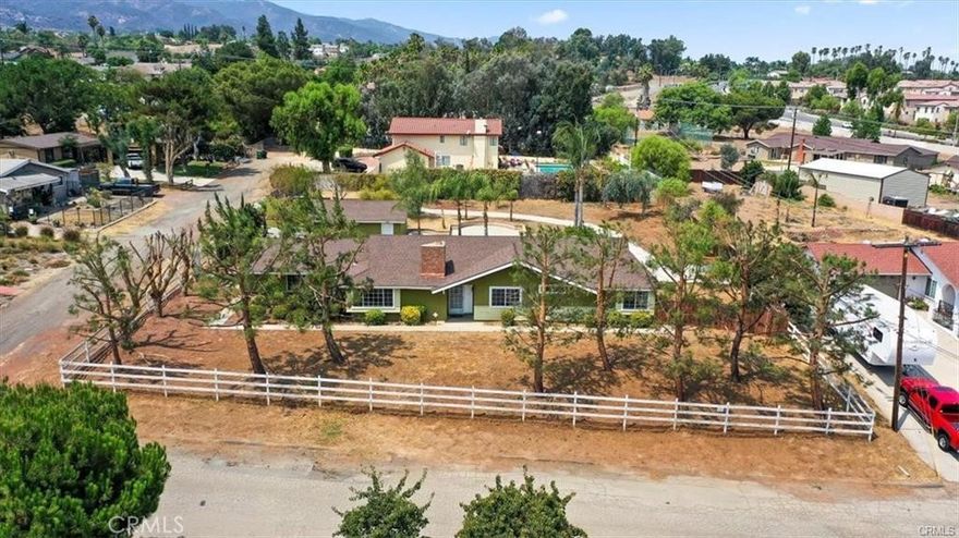 Don’t miss this stunning South Corona ranch-style home, perfectly situated on a huge private corner lot of over 24,000 sq. ft. with lush landscaping throughout. Bring your RV, trucks, and extra cars—this property has space for it all, plus a detached garage for additional storage or workspace. The custom gate provides easy access to the expansive backyard, making this a true entertainer’s dream. Inside, the home offers 4 spacious bedrooms and 2 bathrooms, along with two enormous family rooms, one featuring a beautiful brick fireplace—perfect for cozy winter nights. The open floor plan is designed for comfort and flow, with tile flooring throughout and a newer HVAC system for year-round efficiency. Located near Los Lagos Shopping Center and Santiago High School, with easy access to major freeways, this home offers both privacy and convenience. This is a must-see property that combines space, functionality, and charm—ready for you to move in and enjoy!