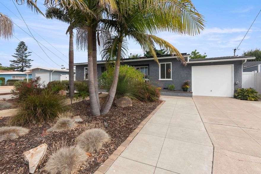 South Oceanside single story gem with lovely wood floors and a raised hearth fireplace in the living room exuding charm and coziness. The master bedroom has a sliding glass door opening to a spacious redwood deck to enjoy the beautiful and private back yard with large avocado and citrus trees. Fully paid solar (NEM 2.0), plus EV charger. Air conditioning and furnace installed in the last few years. Attractive low maintenance landscaping in the front yard with great curb appeal. Walking distance to South Oceanside Elementary School. Very open kitchen and dining room combo with ample windows looking into the trees and back yard. Cute large storage shed in the back and additional parking space in the front. Enjoy this immaculate home in a wonderful South Oceanside neighborhood west of I-5 and close to the beach. Great location.
