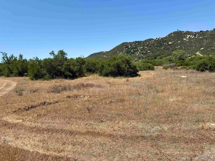 Nestled in the heart of Mt Olympus Estates, this stunning 10-acre parcel offers a rare opportunity to build your dream home or ranch in a peaceful, panoramic valley.  Surrounded by majestic mountains and scenic rock outcroppings, the property enjoys sweeping views of Gomez Creek and a tranquil, natural setting. The land features flat to gently sloping terrain with a slight rise, perfect for a future homesite.  Enjoy the convenience of a 24-ft wide paved road, underground power and water at the property, and a 3-bedroom septic layout already on file. With dual access points, this lot is ideal for horses, outdoor living, and all your toys.  Mt Olympus Estates offers a blend of seclusion and accessibility—just minutes from I-15, yet a world away in peaceful ambiance. This is a rare blank canvas to create the lifestyle you’ve always envisioned.
