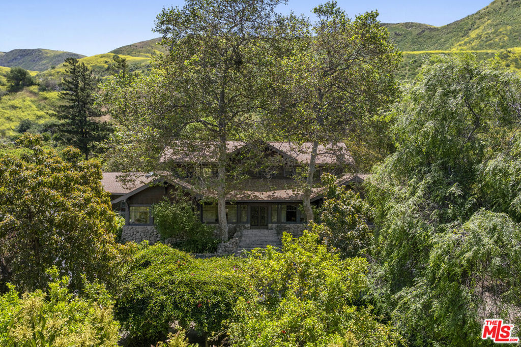 The Converse Ranch was purchased and built out in 1908 by U.S. Steel and banking heir Edmond C. Converse Jr., known as the Millionaire Cowboy. Originally a sprawling 6,000-acre cattle ranch, it's now a 174+ acre legacy estate that's accessed via a dramatic, mile long driveway along the beautiful Santa Clara River Preserve. The original main house and all the historic structures are enveloped by citrus and avocado groves and equestrian facilities.... all with a magnificent mountain backdrop. Just West of the Ranch the 1,000-acre preserve continues, ensuring this spectacular setting will remain for generations to come. Rarely in Southern California can one ride horseback amidst such varied terrain; along the river, meadows and mountains... At the heart of the ranch is the grand 6,635 sq ft. main home that has been carefully restored and updated while maintaining all its original detail and charm. The second owners, one a member of the Doheny family, built the spectacular 40,000-gallon stone swimming pool. The carriage house and three additional guest/staff residences have also undergone thoughtful renovations. Horse lovers will find unlimited potential to expand on the existing facilities that include pastures, arena, 1908 barn structure and a contemporary 5,000 sq. ft. steel barn. Split into two parcels, each with city water supplies. The Eastern parcel features Rose Cottage that overlooks the river valley and out to the Channel Islands. Lastly, but most incredibly, the ranch comes with pre-1914 riparian water rights. This allows owners to pump river water to irrigate all the agriculture on the ranch. A rare opportunity to acquire a property of such historic and natural beauty just 90 minutes from Los Angeles.