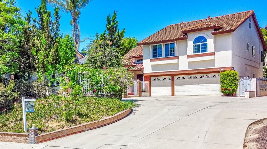 Welcome to 1135 Summitridge Drive, a magnificent two-story estate nestled within the prestigious Diamond Bar Hills community. Meticulously updated with a series of thoughtful enhancements, this exceptional residence is beautifully prepared to re-enter the market. Improvements include the installation of brand-new hardwood flooring, resurfacing of the pool plaster, and restoration of the balcony, among other upgrades. This exquisite home boasts five spacious bedrooms and three bathrooms, offering the perfect blend of sophistication, comfort, and functionality. Step into the grand formal entryway, where soaring ceilings and gleaming marble flooring set an elegant tone. The expansive living area, adorned with rich hardwood floors, seamlessly flows into the gourmet kitchen, featuring a marble island with built-in stoves, a cozy breakfast nook, ample cabinetry, a pantry, and an adjacent dining area with a ceiling fan. The inviting family room is an entertainer’s dream, complete with a home bar, a cozy fireplace, and sliding glass doors that open to a serene backyard retreat. On the main level, you’ll also find a guest bedroom, a full bathroom with a shower, a laundry room, and direct access to the three-car garage. Ascend the staircase to discover the lavish primary suite, a true sanctuary featuring a private office space, a spa-like ensuite bathroom with a deep soaking tub, dual vanities, a separate shower, and a private balcony—perfect for enjoying breathtaking treetop and mountain views. Down the hallway, three additional generously sized bedrooms with hardwood flooring share a beautifully appointed full bathroom. The front of the property showcases a sparkling pool and jacuzzi, while the backyard oasis offers a tranquil, trail-like setting ideal for both lively gatherings and peaceful retreats. The property features a solar power system to enhance energy efficiency and support eco-friendly practices. Located in an award-winning California Distinguished/Blue Ribbon school district, this exceptional home offers a harmonious balance of luxury and convenience—just moments from the Civic Center, Walmart, and an array of fine dining options. Experience secluded, nature-inspired living with effortless access to urban amenities in this remarkable Diamond Bar estate.