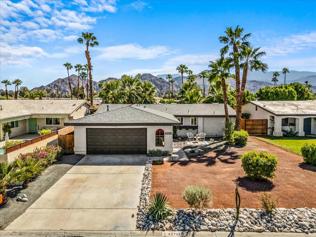 Bask in the breathtaking beauty of desert living from this recently upgraded California ranch-style retreat, perfectly framed by panoramic mountain views. This 2-bedroom, 2-bath oasis blends modern comfort with timeless appeal--featuring paid solar (15 panels), no HOA, and a host of thoughtful enhancements throughout. Step inside to an airy open floor plan where sunlight dances across waterproof Pergo floors, uniting a reimagined kitchen with granite countertops, stainless steel appliances, bar seating, and a seamless connection to the spacious living room and backyard. Designed for relaxation and entertaining alike, the South facing outdoor space boasts a lush yard, upgraded landscaping, and uninterrupted vistas of the Eisenhower mountains that capture the essence of California desert living. The primary suite is a private haven with direct patio access, California closets, and a spa-inspired ensuite with a walk-in shower and custom vanity. A comfortable guest suite mirrors the same care and detail. The home also features a spacious 2 car garage. Inquire about the existing assumable 3.5% Navy Federal Credit Union adjustable-rate mortgage. Ideal as a full-time residence, vacation escape, or investment property--this home sits minutes from Gerald R. Ford Elementary, the Indian Wells Tennis Garden, and world-class golf, dining, and shopping. Don't just visit the CA desert--live its magic. Washer/Dryer, Fridge included. Some furniture is available outside of escrow. First showings at first Open Houses, Sat & Sun, Oct 11th and 12th, 12-3pm