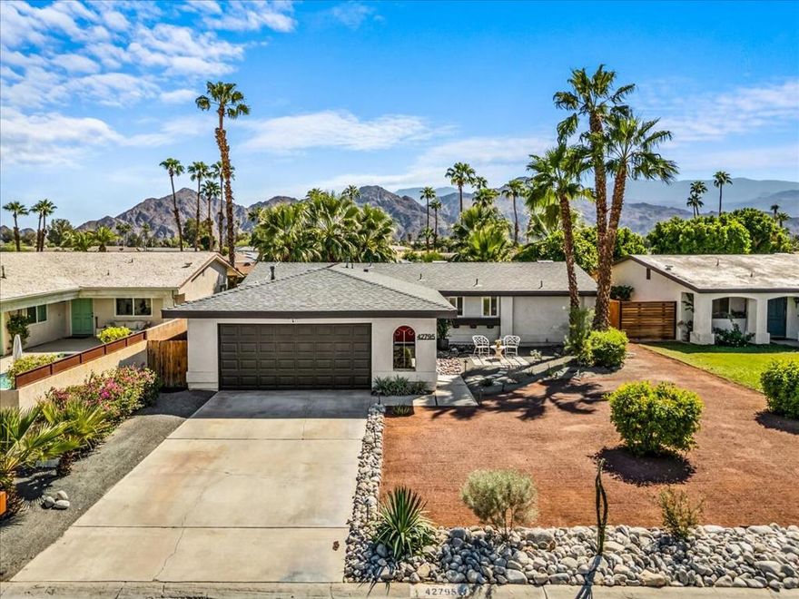 Bask in the breathtaking beauty of desert living from this recently upgraded California ranch-style retreat, perfectly framed by panoramic mountain views. This 2-bedroom, 2-bath oasis blends modern comfort with timeless appeal--featuring paid solar (15 panels), no HOA, and a host of thoughtful enhancements throughout. Step inside to an airy open floor plan where sunlight dances across waterproof Pergo floors, uniting a reimagined kitchen with granite countertops, stainless steel appliances, bar seating, and a seamless connection to the spacious living room and backyard. Designed for relaxation and entertaining alike, the South facing outdoor space boasts a lush yard, upgraded landscaping, and uninterrupted vistas of the Eisenhower mountains that capture the essence of California desert living. The primary suite is a private haven with direct patio access, California closets, and a spa-inspired ensuite with a walk-in shower and custom vanity. A comfortable guest suite mirrors the same care and detail.  The home also features a spacious 2 car garage.  Inquire about the existing assumable 3.5% Navy Federal Credit Union adjustable-rate mortgage. Ideal as a full-time residence, vacation escape, or investment property--this home sits minutes from Gerald R. Ford Elementary, the Indian Wells Tennis Garden, and world-class golf, dining, and shopping. Don't just visit the CA desert--live its magic. Washer/Dryer, Fridge included. Some furniture is available outside of escrow.  First showings at first Open Houses, Sat & Sun, Oct 11th and 12th, 12-3pm