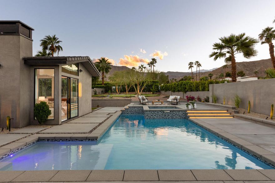 Welcome to 71501 Sahara Road, where the Desert meets Dazzling Design in Rancho Mirage. This California Ranch has been expertly taken down to the studs, expanded to an impressive 2,406 square feet, and completely reimagined. Nestled in the tranquil enclave of Magnesia Falls Cove, you're just a brisk walk away from the desert's top dining--perfect for working up an appetite or working off that extra appetizer!Step inside to find the Great Room, where vaulted ceilings and jaw-dropping views of the San Jacinto and San Gorgonio Mountains make every day feel like a staycation. The kitchen is a culinary playground with new GE Monogram appliances, custom cabinetry, and a honed quartz-topped island that practically insists you host brunch. A spacious walk-in pantry ensures you're always ready for impromptu gatherings.The living area is anchored by a cozy stone-surround fireplace, while the dining space boasts a classy bar with a wine fridge--because why not keep the party going? Sliding glass doors disappear into the walls, leading you to your own backyard paradise.The expansive yard is nothing short of spectacular, featuring a sparkling pool and spa, a vast green lawn with a putting green, and even a bocce ball court, all gracefully shaded by mature Palo Verde trees. It's a slice of heaven with a side of fun!Each bedroom suite is a personal retreat with walk-in closets, and the primary suite offers pool access, gorgeous views, and a fireplace for those rare chilly desert nights. The oversized, air-conditioned garage with epoxy floors will have your car thanking you.Welcome to your oasis of elegance and excitement in Rancho Mirage--where home truly feels like a getaway!