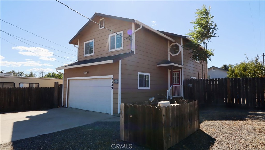 Turn-Key Corner Lot Home with Spacious Layout! This inviting four-bedroom, two-and-a-half-bath home sits on a desirable corner lot just five minutes from Clear Lake—perfect for boating, water sports, and bird watching. Upstairs offers four bright and airy bedrooms, including a primary suite with walk-in closet and full bathroom, while the large windows throughout fill the home with natural sunlight. The main floor features charming arched doorways, a dining area with sliding glass doors that open onto the sunny, fully fenced backyard—ideal for gardening, entertaining, or simply enjoying the outdoors. With the garage opening directly into the kitchen, unloading groceries is a breeze—and there’s ample parking for guests as well. Located within walking distance of Pomo Elementary School, this turn-key property combines comfort, convenience, and lifestyle. Move-in ready and full of charm—this is the perfect place to put down roots!