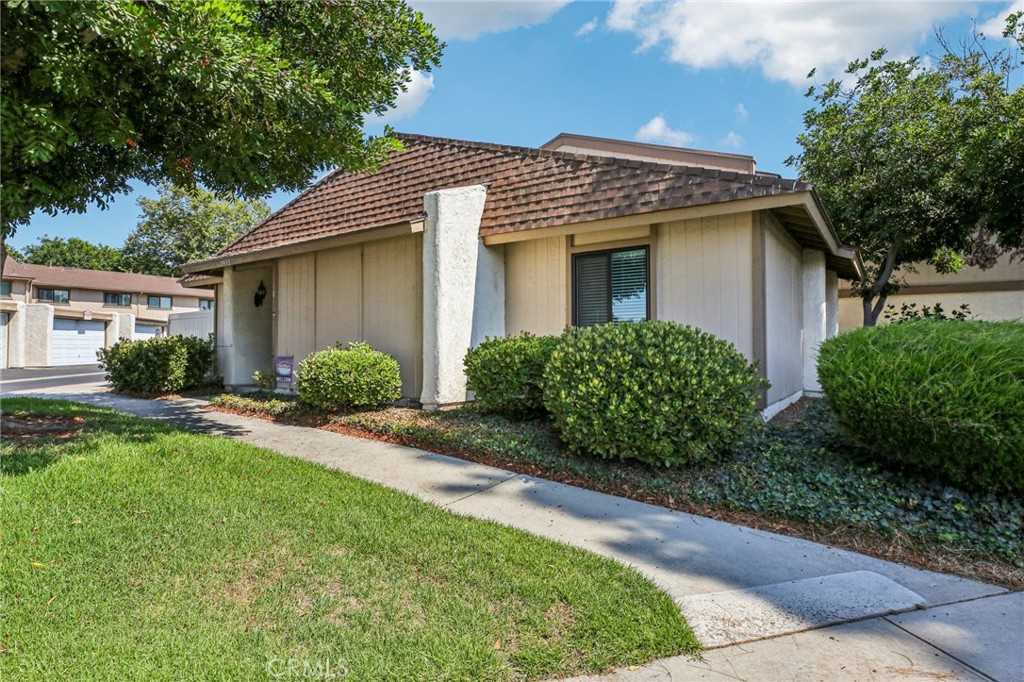 Looking for a townhome that lives like a detached home? This is it! Prime end-unit location. Single story with only 1 common wall, and with a generous backyard - one of the largest in the entire tract! Set in the sought-after community of Smoketree, this home shows pride of ownership at every turn. Key features include engineered wood floors throughout, tastefully upgraded Kitchen and Bathrooms, and an open floorplan with abundant natural lighting. Newer high-efficiency AC and furnace, and water heater. The 2 car garage includes extra storage space and full size laundry hookups. Additional energy efficiency upgrades include new ductwork, insulation, dual-pane windows and an attic radiant barrier. The HOA amenities include pool, spa, sport court, and clubhouse. Central location minutes to everything...freeways, shopping and more, and it is in the VP High School district. This is a very coveted model in Smoketree, and will not last long on the market!