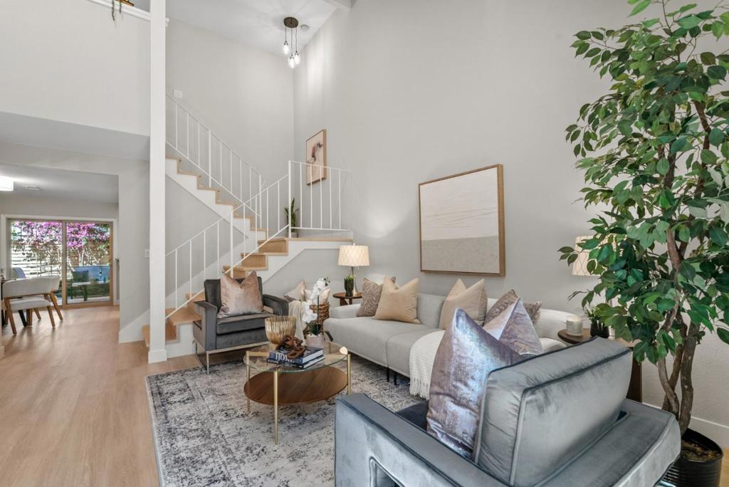 Welcome to one of the most unique properties on the market! This one bedroom walkup TOWNHOUSE is oversized at 1086 square feet and offers the space and privacy you're looking for. This is NOT a condo, there are no neighbors above or below you. Another standout feature is a full sized 2 car attached garage, an incredibly rare find in this price range. You'll realize cathedral ceilings, abundant natural light and a bright, open floor plan that truly lives large. The remodeled kitchen and bathrooms add a modern touch, while the interior laundry, central air conditioning and fresh interior paint make this home as comfortable as it is stylish. The primary bedroom is massive, complete with three closets, including a walk-in, and plenty of space for a home office or reading nook. Enjoy the best of indoor and outdoor living with two private outdoor areas: a front courtyard and a backyard patio, perfect for relaxing or entertaining. Located in San Jose, right in-between Downtown Campbell and Santana Row, youll love the central location. The low HOA and access to a heated community pool make this an unbeatable value. Come check us out! This home is an 11-out-of-10!