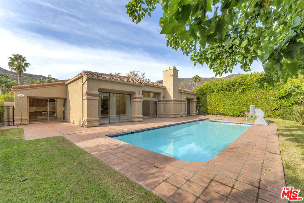 "Malibu Country Estates" An approx. 3,000 sq ft custom built four bedroom single story home adjacent to Pepperdine University with sewer, sidewalks, streetlights and underground utilities. Custom home built with private pool/spa and an oversized (approx. 700 sq ft) three car garage. Light, bright and airy with a great open floor plan. High vaulted ceilings thru-out, LED recessed lighting, built-in cabinetry and wet bar. Living room with FP, separate family room, a dining room and separate maids quarters. Large Primary Suite with FP and custom built walk-in closet. Extremely private back yard with its own pool/spa w/remote. Pepperdine University amenities available (Olympic size swimming pool, six tennis courts, gym, track and more. Also available for lease at $15,000 month.