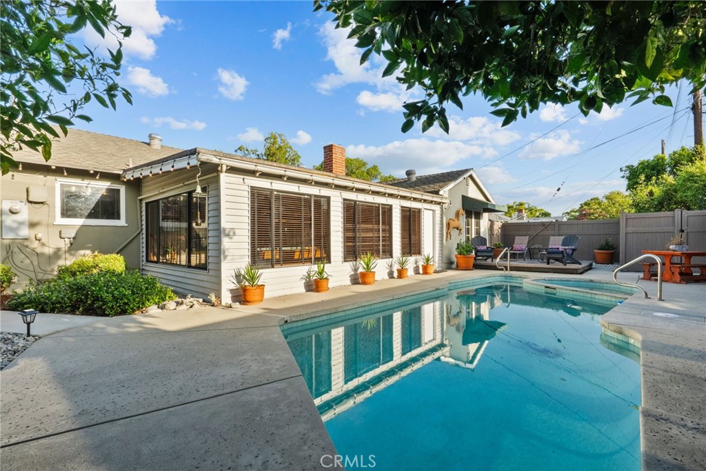 Welcome to 9548 Cedros Avenue, a beautiful single-story pool home nestled on a picturesque tree-lined street. This warm and inviting residence offers the perfect blend of charm, space, and functionality- ideal for families, creatives, and entertainers alike.
Featuring 4 spacious bedrooms (one currently serving as a bright and inspiring art room) and 2 well-appointed bathrooms, this home is designed for comfort and versatility. The sunroom has been transformed into a lively game room, complete with a full-sized pool table and a casual lounging area- an ideal spot for entertaining guests.
Step inside to discover classic hardwood floors, elegant crown moulding, and a cozy fireplace that creates a welcoming ambiance. Skylights bathe the interior in natural light, while custom paint and wallpaper accents infuse the home with personality and character.
Enjoy your morning coffee or unwind in the evenings on the deck just outside the back bedroom, surrounded by peaceful outdoor views. The functional layout includes a dedicated laundry area leading to the second bathroom and direct access to the side yard, perfect for poolside convenience.
The backyard is your private oasis, complete with a custom vinyl fence, mature citrus trees, and a sparkling pool, creating the perfect backdrop for summer gatherings or serene relaxation.
Additional highlights include all stainless steel appliances with a Fisher & Paykel 5-burner cooktop, copper plumbing, new sewer piping under the house, a new pool pump, new exterior paint, and a generous driveway with ample parking. This home also has easy access to the 5, 405, and 118 freeways, and convenient proximity to CSUN, shopping, and dining.
This is a rare opportunity to own a truly special home that blends classic charm with everyday functionality. Don’t miss your chance! Schedule your private showing today and envision life at this lovely home.