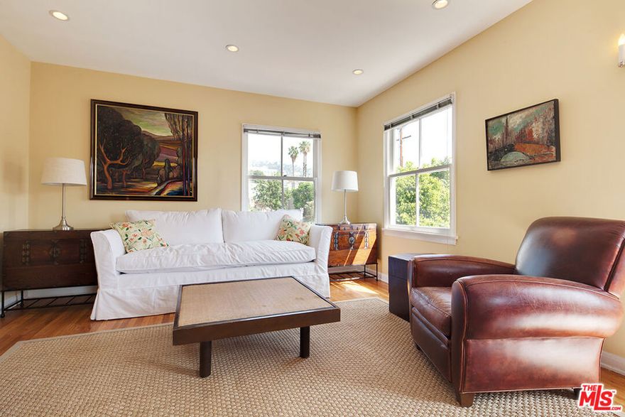 Cozy vintage 1 bedroom unit in one of the best West Hollywood locations. 2nd floor of a 2 story duplex with hardwood floors throughout. All new electrical, plumbing, heating & air conditioning. The kitchen features the original 1940's cabinets & tile counters - all in really great condition - and, a vintage O'Keefe Merrit stove that works great! Totally redone bathroom with white marble floors & tiled shower / tub. Lots of light from 4 directions & views to the Hollywood Hills. Includes single car garage & stack washer /  dryer unit.