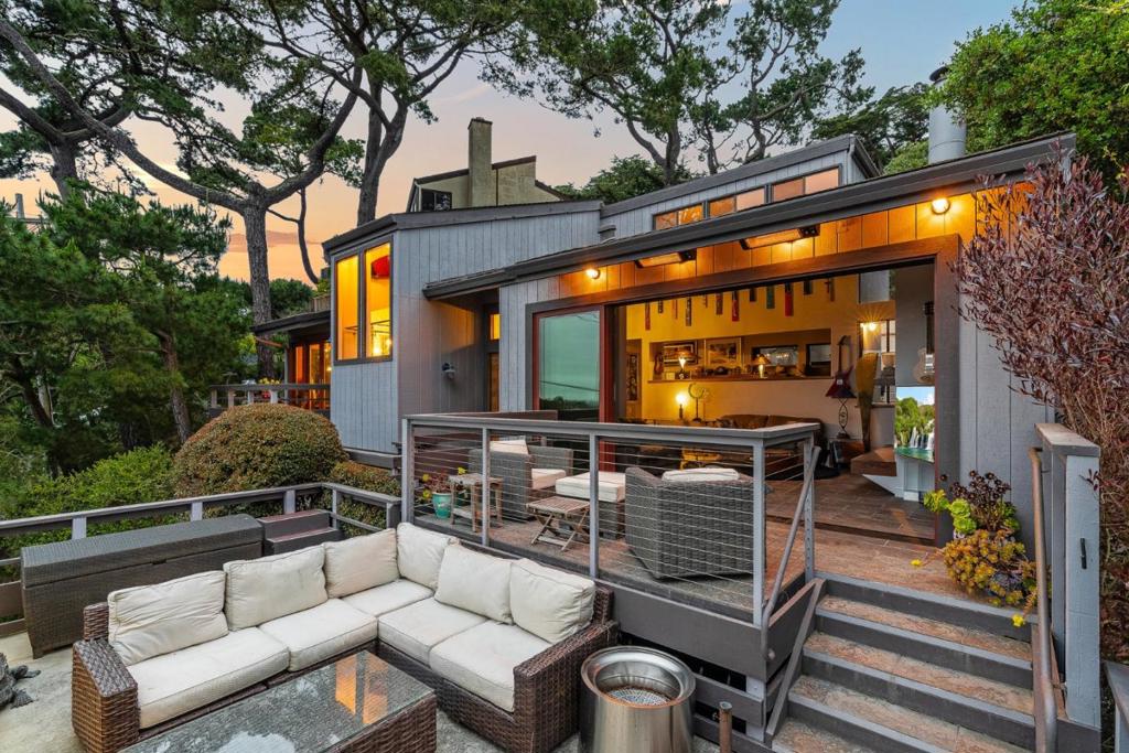 Experience breathtaking ocean and Point Lobos views from every room in this spectacular Carmel home. Designed to maximize its incredible setting, this property features wall-to-wall accordion glass doors that open to a spacious deck, creating an effortless indoor-outdoor living experience. From sunrise to sunset, enjoy sweeping views of the Pacific from the comfort of your living room, bedroom, or while entertaining on the deck. The backyard is a showstopperbeautifully landscaped and ideal for gatherings, relaxation, or soaking in the coastal breeze. Inside, luxury finishes are found at every turn, blending high-end style with timeless comfort. Just blocks away from downtown Carmel, world-famous Carmel Beach, and the renowned Pebble Beach Lodge, this home offers not only views and elegance, but also unparalleled access to some of the most sought-after locations on the California coast. Whether you're enjoying a quiet evening or hosting friends, every moment here feels like a postcard.
