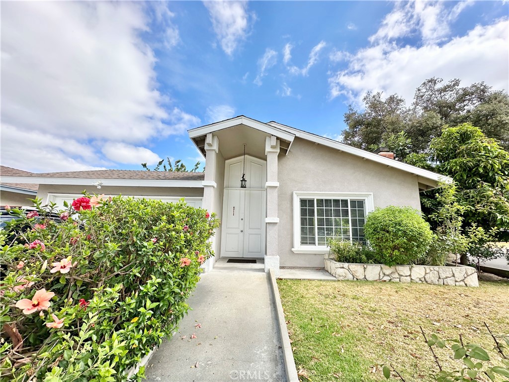 Welcome to 12947 Arabella Place - A beautifully updated single-story home tucked away on a quiet cul-de-sac in one of Cerritos' most desirable neighborhoods. This charming 3-bedroom, 2-bathroom residence offers an inviting blend of comfort, functionality, and tasteful upgrades across approximately 1,789 square feet of living space. Step inside to discover an open and airy floor plan featuring soaring cathedral ceilings, a stunning flagstone fireplace, and abundant natural light throughout. The remodeled kitchen is a chef’s delight with granite countertops, custom cabinetry, and seamless flow into a cozy family room with recessed lighting and ceiling fans. A formal dining area opens through sliding glass doors to a private backyard deck, perfect for indoor-outdoor entertaining. The spacious primary suite boasts a thoughtfully enlarged ensuite bathroom with granite finishes and ample storage. Additional highlights include wood flooring in bedrooms, newer textured ceilings, central HVAC, and an attached two-car garage with direct home access and laundry hookups. Situated on a 5,597 sq ft lot, the landscaped backyard features a covered patio, built-in seating, and mature fruit trees—offering a serene outdoor retreat. Located within the top-rated ABC Unified School District and just minutes from parks, Cerritos Town Center, and the public library, this home combines tranquil suburban living with urban convenience.