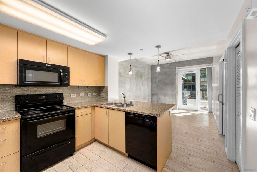 Amazing opportunity for a first-time buyer or investor! This move-in-ready third-floor residence in the iconic Smart Corner building offers a stylish Downtown lifestyle. Featuring wood-textured ceramic tile flooring throughout, exposed cement accents for a modern loft-like feel, and a contemporary ceiling fan that anchors the living space. Enjoy seamless indoor-outdoor living from the spacious private balcony that is perfect for relaxing or entertaining. The upgraded kitchen showcases granite countertops, designer tile backsplash, pendant lighting, and an eat-at counter ideal for casual dining. Includes a dedicated parking space and a rare assumable VA loan at 3.25%—an exceptional value in today’s market.  Smart Corner is an all-encompassing hub of work, play, shop, and live! It is conveniently located near the 163 freeway, I-5, Highway 94, Petco Park, the Gaslamp Quarter, San Diego City College, and Balboa Park. A trolley station located below the development ensures Smart Corner has all an urban dweller could want. Amenities include 20th floor roof-top sun deck with forever views of the city skyline, 10-person hot tub, barbecue area, wet bar, 2nd floor Fitness Center, PLUS on-site management, and security.