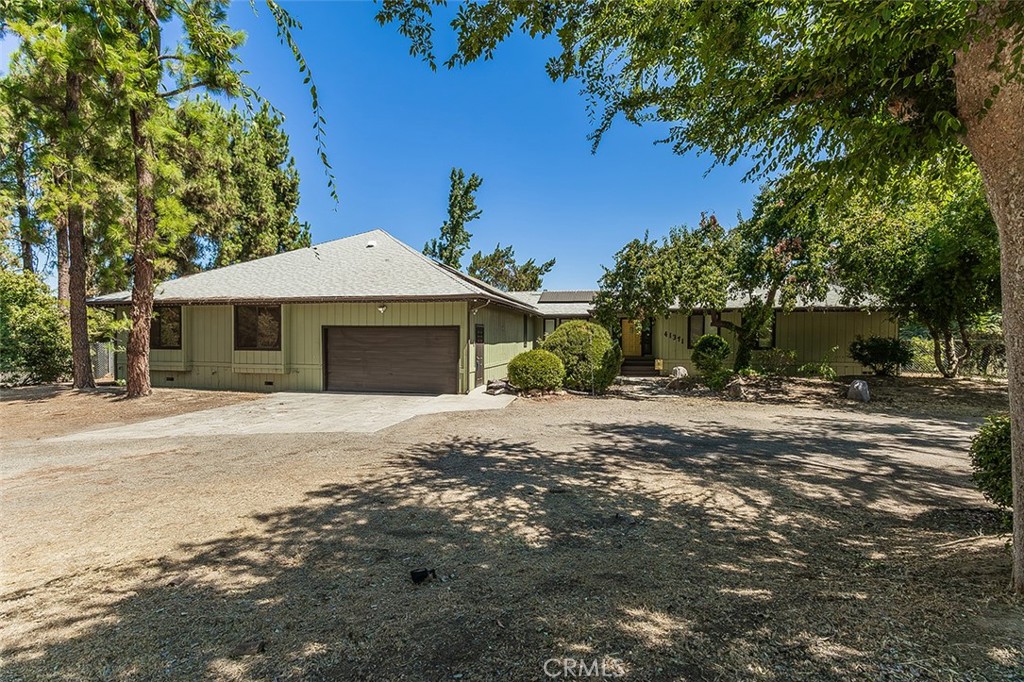 This beautiful property, located in the Rolling Hills community, offers the perfect blend of privacy, comfort, and outdoor enjoyment. Nestled on one acre, the main house features 3 bedrooms, an office and 2 bathrooms, with a modern kitchen that has been tastefully renovated to suit the most discerning chef. Plus, enjoy the peace of mind of a brand-new roof, ensuring years of worry-free living. The connected ADU (Accessory Dwelling Unit) offers 2 additional bedrooms, 1 full bathroom, and a fully equipped kitchen and living room with separate access ideal for guests, extended family, or even rental income potential. Step outside and immerse yourself in the lush grounds, where you'll find fruit trees, a garden, and a large grassy area perfect for play or relaxation. Enjoy endless hours of fun with the zipline, tree climbing steps, and tree obstacle course or retreat to the playhouse for the little ones. Two expansive decks provide serene views of the Olive Orchard and nearby walking trails, while the porch swing invites moments of peaceful reflection. In addition to its tranquil setting, this home is conveniently located near shops and amenities, making it easy to access everything you need while still enjoying the peace of rural living. Whether you're entertaining or simply unwinding, this home offers an idyllic setting. Don't miss the opportunity to call this one-of-a-kind property your own!