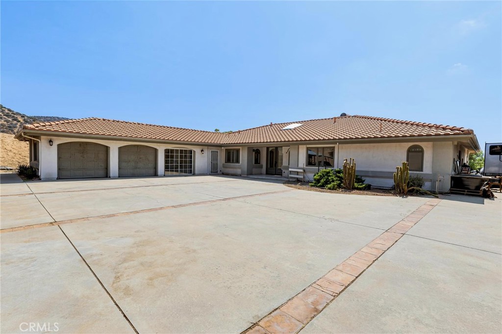 Welcome to Dream Horse Ranch in Acton, CA—where horses come first and the home follows. Located at 35710 Red Rover Mine Road, this 4.86-acre property is fully fenced with an electric gate, sits on a paved road, and is connected to natural gas utilities. Offering the perfect balance of wide-open ranch living and well-planned equestrian facilities, this ranch is truly a rare find in the heart of Acton horse country.
Equestrian features include two barns—one originally an 8-stall barn now fully insulated and converted for multiple uses such as a workshop, gym, or studio, or use your imagination and a 10-stall barn with setups for automatic waterers, a fly spray system that may need some work, and lighting.
The property also offers an outdoor wash rack, hay shed, round pen, extra horse stalls, and an arena area ready for fencing or to be used as is. A back-gated entrance makes trailer access simple and convenient.
The spacious 3,078 sq. ft. residence, built in 1990, features 4 bedrooms and 3.5 bathrooms. The home’s layout includes a living room with fireplace, formal dining room, kitchen with island and breakfast nook open to the family room an enclosed sunroom, and a breezeway leading to the 3-car garage (with one bay converted into an office). With solid bones and great potential, the home would truly shine with some updating to match the incredible property.
Additional highlights include a shipping container for tack, tools, or feed storage, along with a ready-to-go chicken coop/animal pen for added livestock or hobby farming flexibility. Surrounded by panoramic mountain views, this property is designed for boarding, training, or simply enjoying your horses at home. Dream Horse Ranch is more than just a property—it’s a lifestyle.