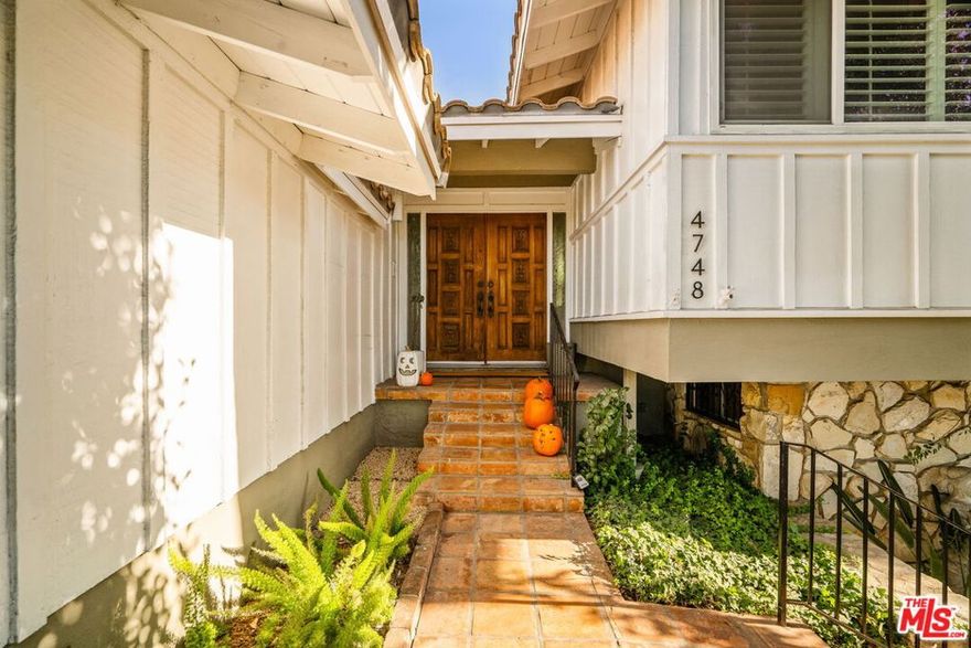 MCM dream come true with pool in Glassell Park's coveted Eastridge Estates! Perched on a tranquil hillside, this 4BR/3BA residence offers a harmonious blend of classic 1960's architecture and contemporary refinement. Built in the Ray Watt community developed by one of Los Angeles' most prolific builders of the era, this is a true mid-century timepiece with thoughtful updates to the bones and systems. Modern improvements include solar panels, engineered hardwood flooring, and newer plumbing, ensuring efficiency and comfort while preserving its original charm. The double-door entry welcomes you to the foyer on original terrazzo floors with soaring vaulted ceilings and a decorative fireplace creating a warm ambiance, surrounded by gorgeous gallery windows. Enjoy cooking in the light-filled kitchen with all-electric appliances, and sliding doors that extend effortlessly onto a patio perfect for leisurely mornings or evening cocktails with a view of the pool. Upstairs, three serene bedrooms await, including a primary suite with an en-suite bath and ample his and her closet space. The lower level features a retro sunken den showcasing original wood paneling, retro tiled floors, and a vintage mini bar that calls for cocktail hour! An additional bedroom and bath on this floor provide flexible options, whether for guests or a home office. Just off the den, the sparkling pool and lush landscaping create a private retreat with multiple entertaining areas.This home perfectly balances vintage character with smart modern upgrades. A two-car garage with EV charger connects to the kitchen for easy and secure storage. Set in the heart of NELA and close to local treasures like Little Ripper Wine Bar, Highland Park Cafe, Dunsmoor, The Grant, and not one, but TWO Targets! Commuting is a breeze with easy access to the 2 & 134 freeways. Zoned for sought-after Delevan Drive Elementary and Eagle Rock High School. Now's your opportunity to own a fabulous pool home in Eastridge Estates!